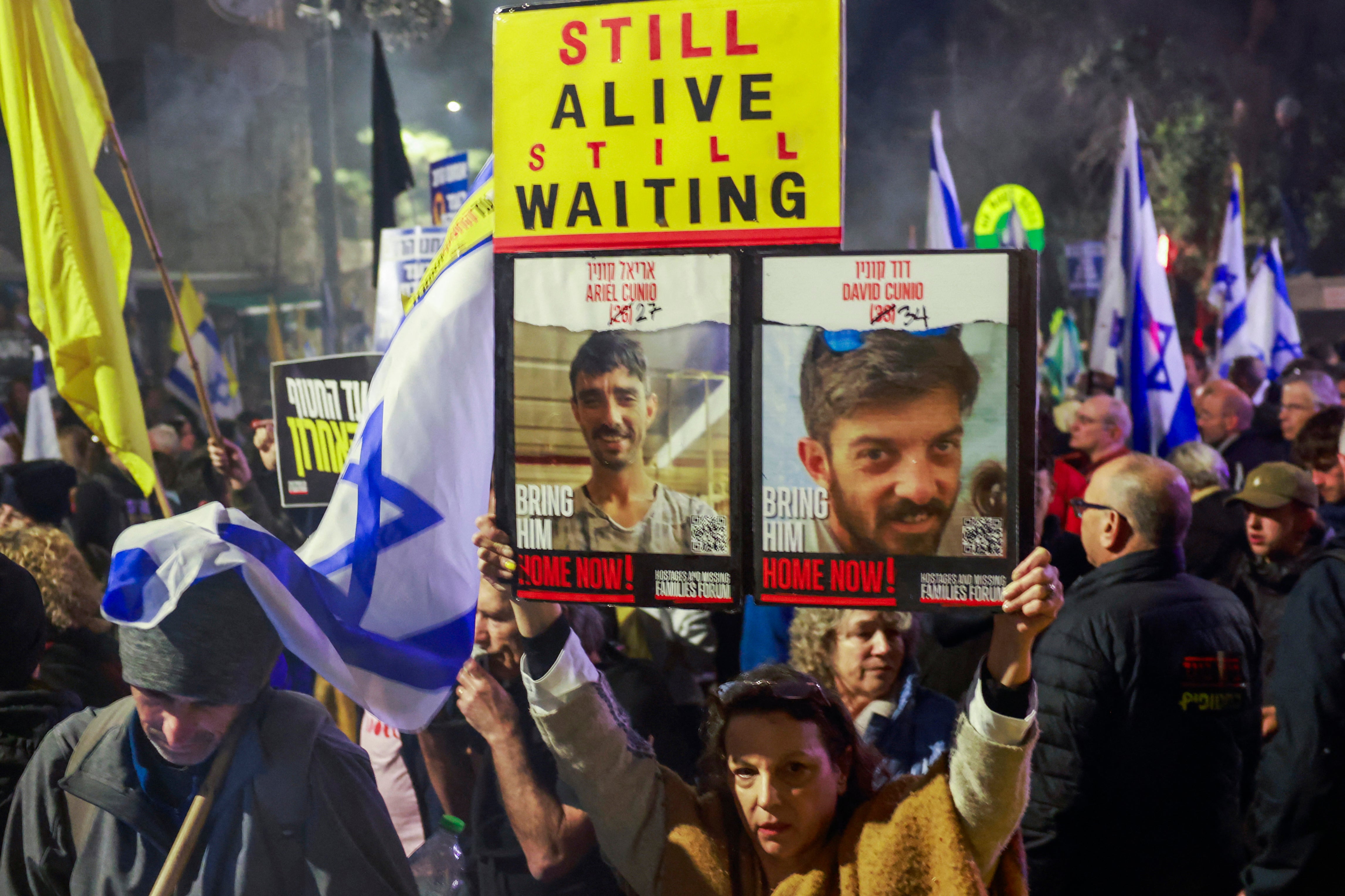 <p>Relatives and supporters of Israelis held hostage in the Gaza Strip by Palestinian militants since October 2023, lift placards during a rally calling on the government for a deal that would bring all the remaining captives back, outside the prime minister residence in Jerusalem on March 2</p>