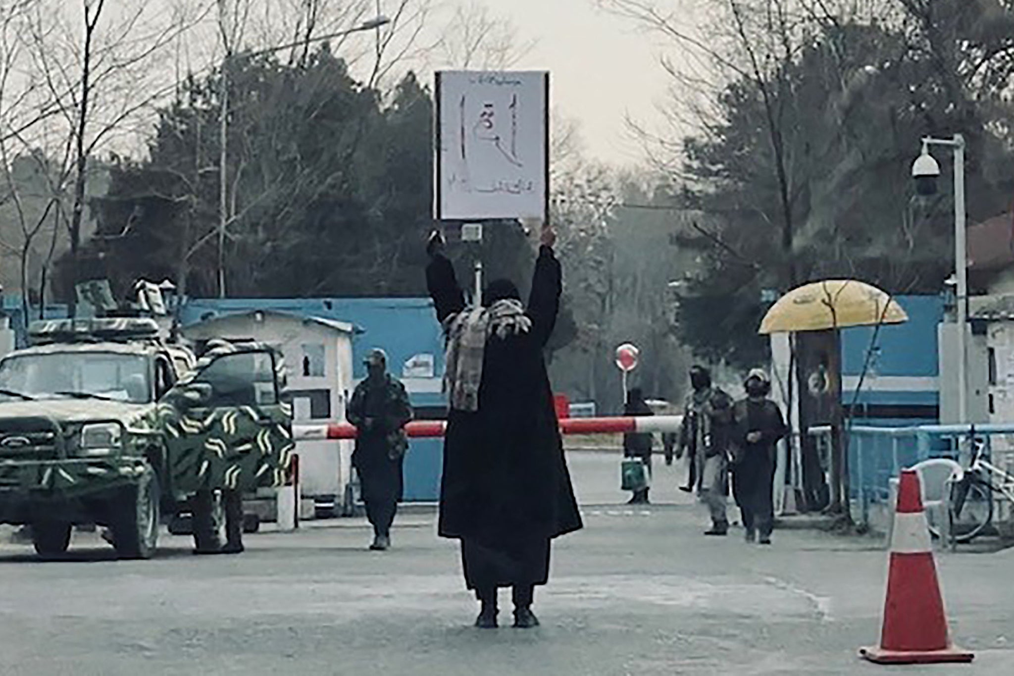 A student protesting alone against the ban on women's higher education, outside Kabul University