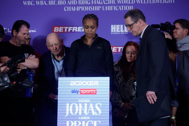 <p>Coach Joe Gallagher (left) observes as Natasha Jonas makes weight</p>