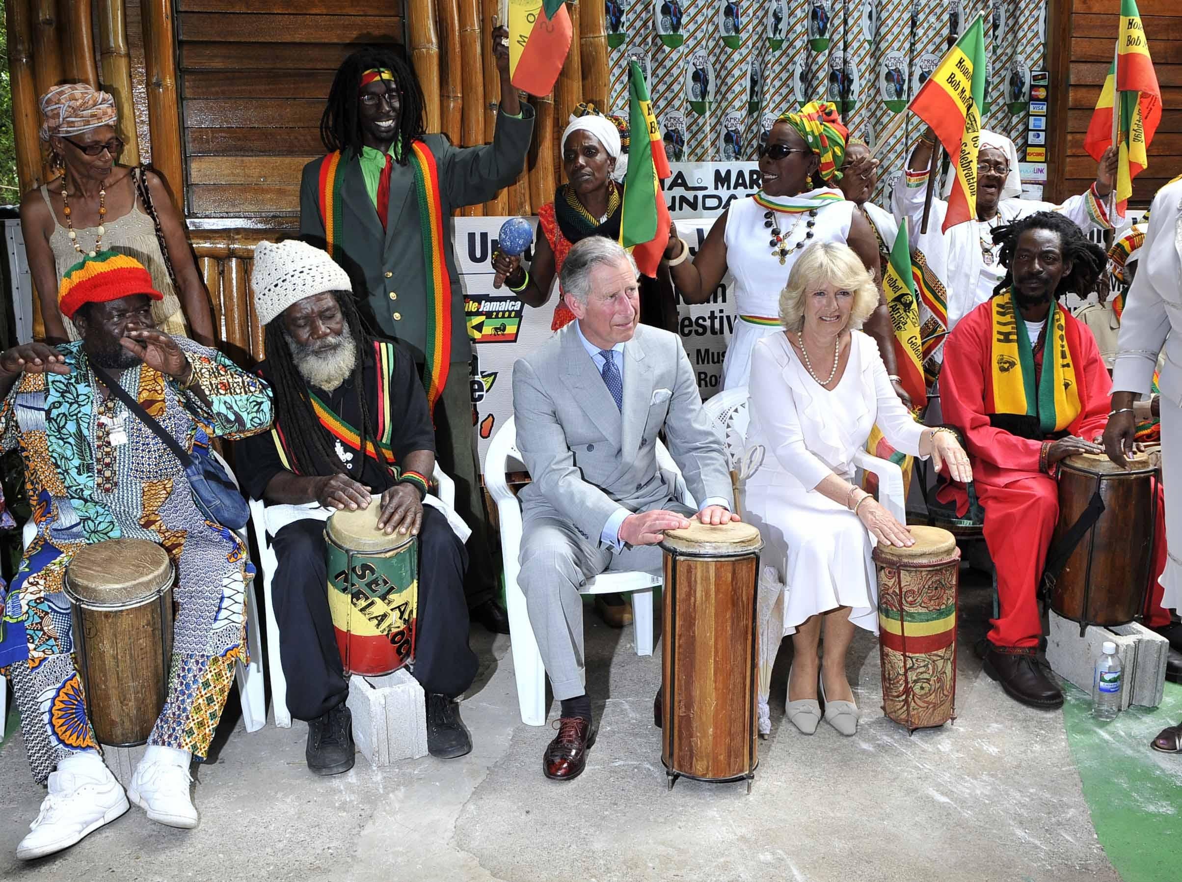 The then-Prince Charles and the Duchess of Cornwall, Camilla, play with a rasta band at the home of the late reggae singer Bob Marley in Kingston, Jamaica in 2008