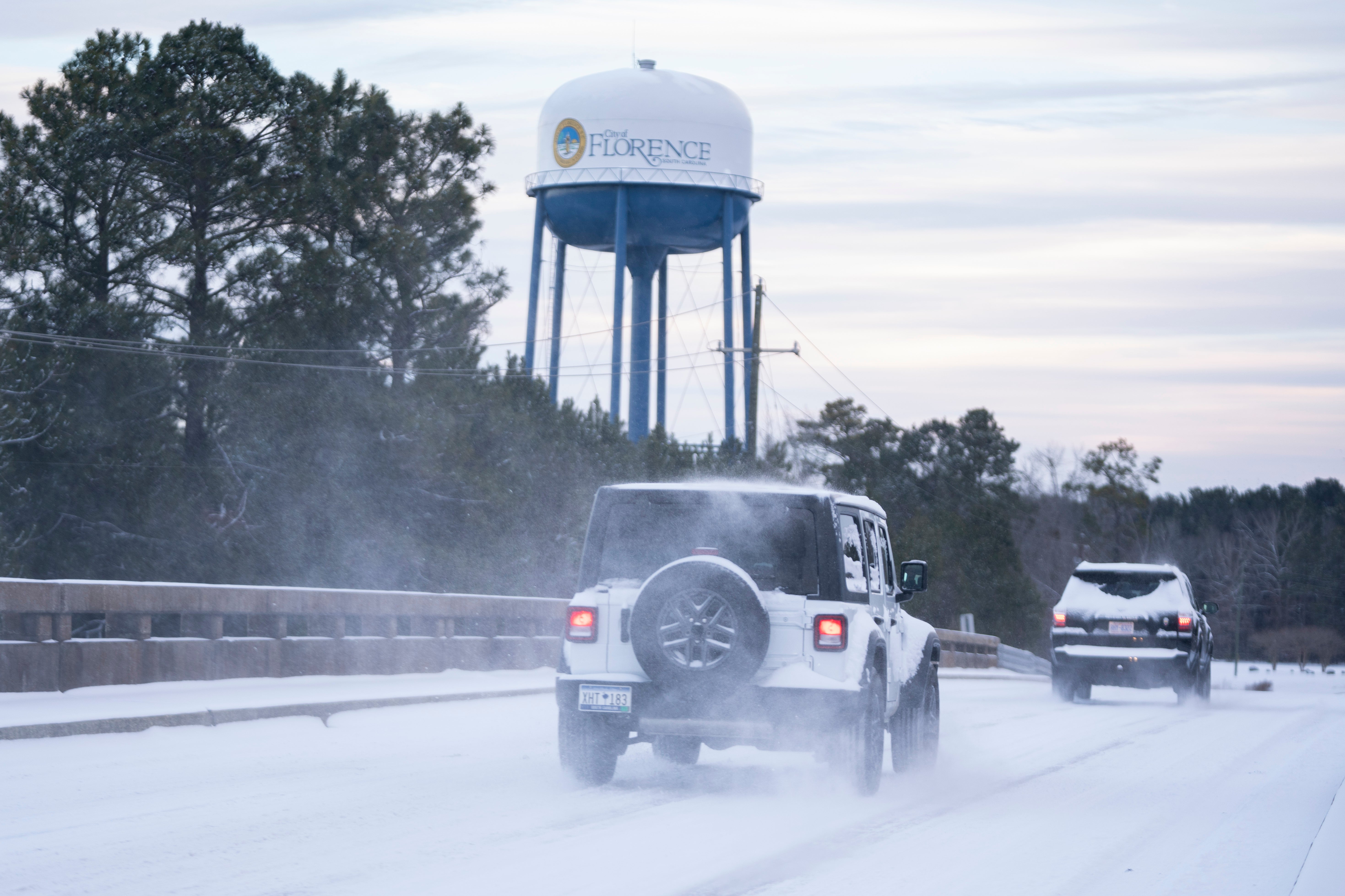 Motorists drive in snow near the I-20 and I-95 exchange on January 22, 2025, in Florence, South Carolina. The state ranked as the worst for drivers. While snow is rarely seen, it does happen and is one of the many challenges the state’s drivers face