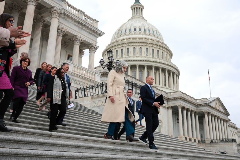 Members of House Democratic leadership including Kathleen Clark and Hakeem Jeffries descend the Capitol steps.