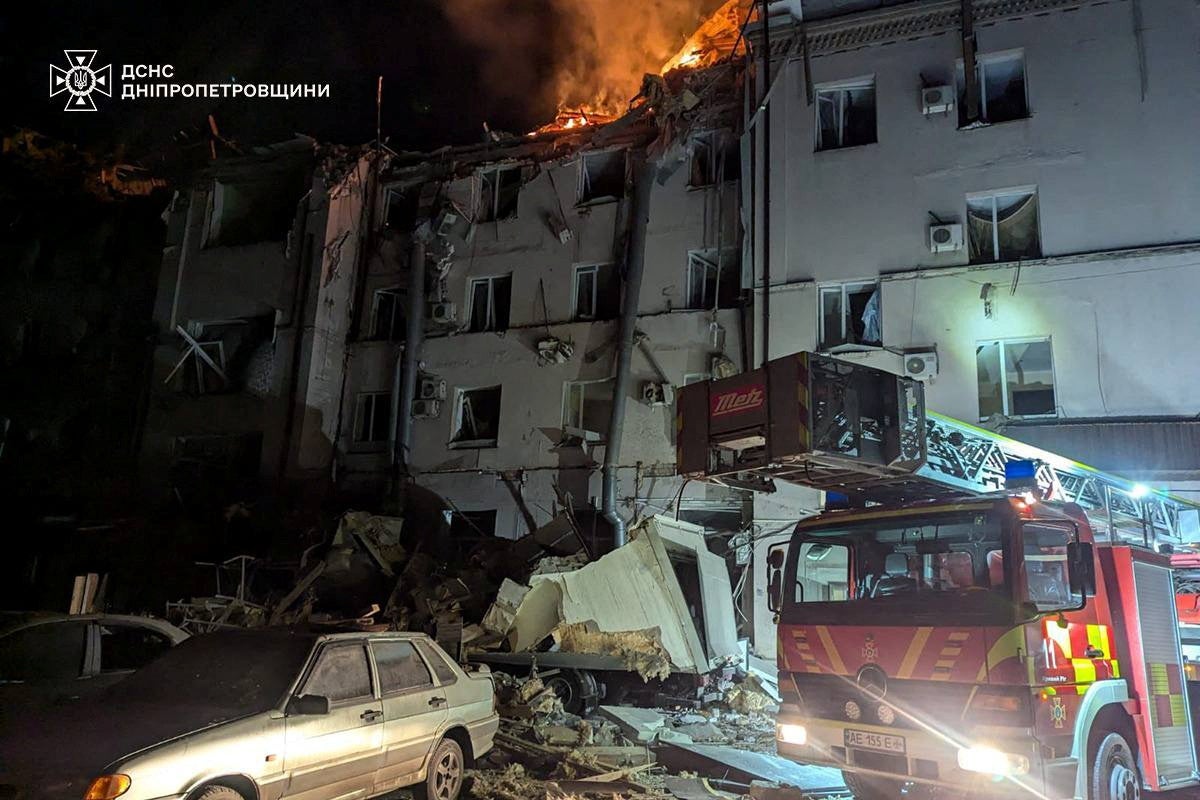 A fire truck is parked outside a destroyed building following a Russian missile strike on Kryvyi Rih