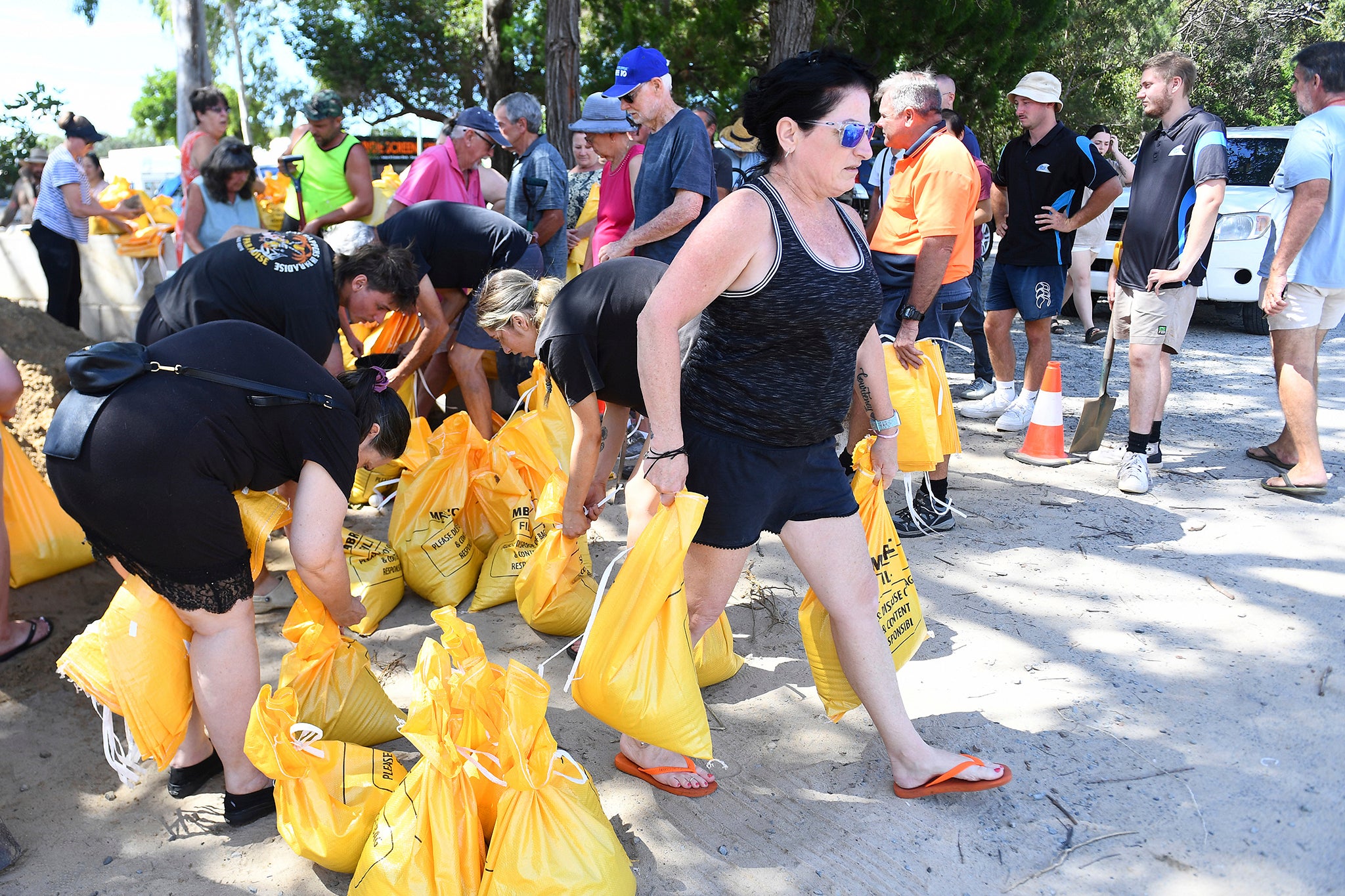 Residents collect sandbags at a depot on Bribie Island, Queensland