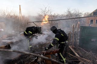 Ukrainian firefighters put out a fire following a Russian air attack in Kostiantynivka, Donetsk