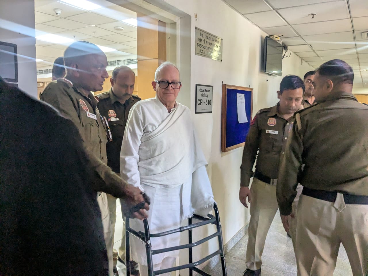 Delhi police officials guiding Christian Michel out of the courtroom on 7 March 2025