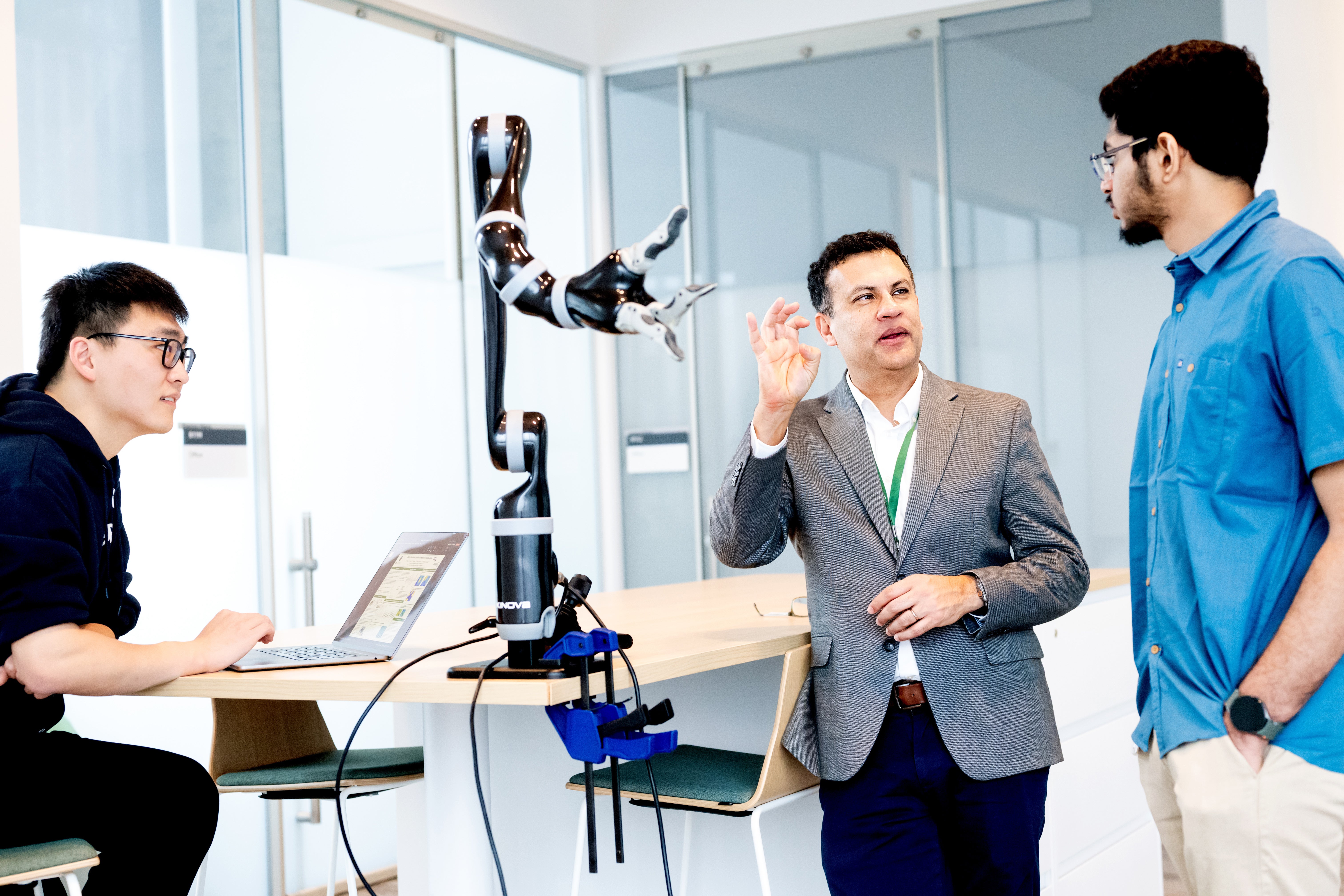 Dr Karunesh Ganguly, centre, works in his lab with graduate students Harsha Peesapati, right, and Runfeng Miao, left