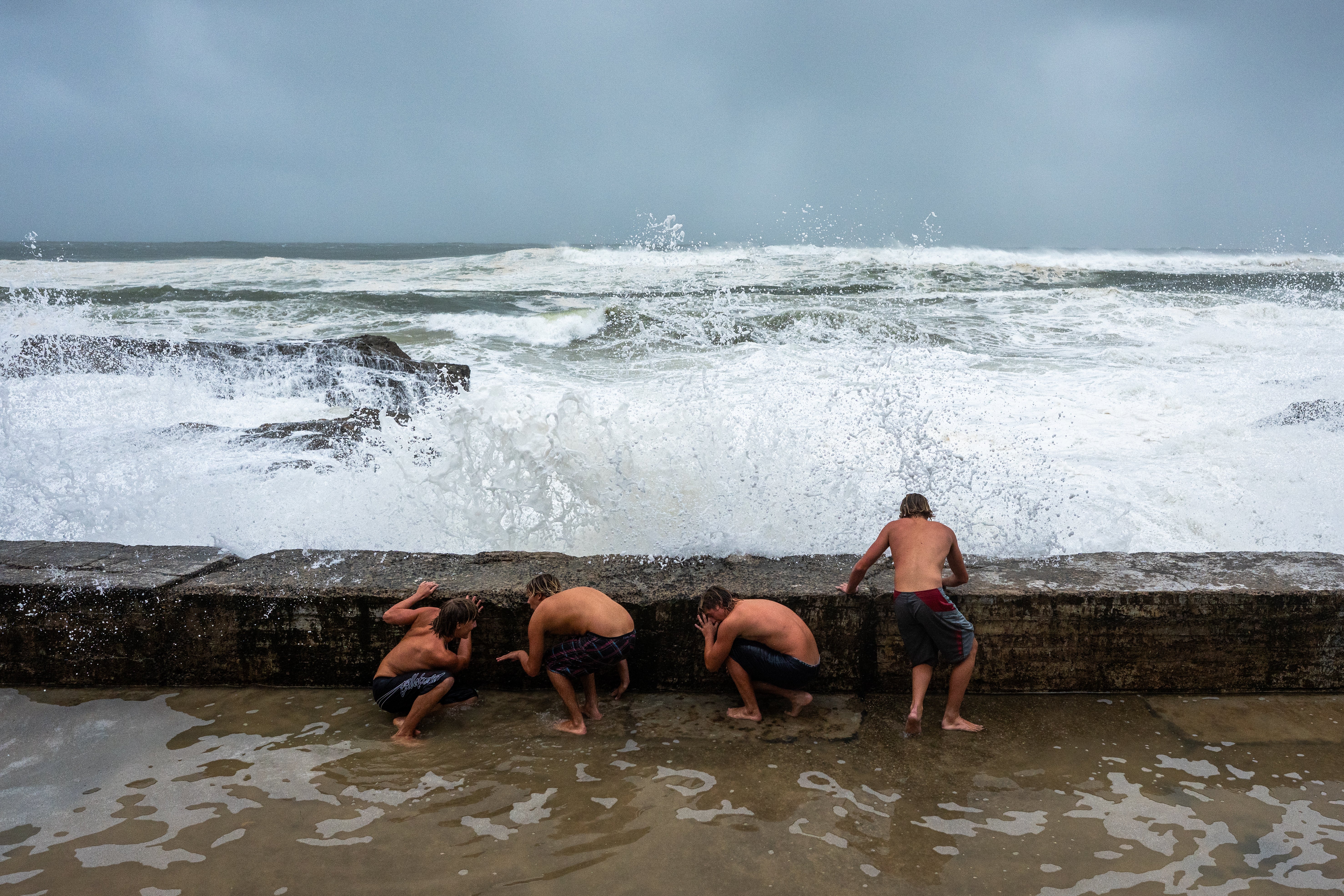 A group evade a crashing wave on 6 March 2025 in Tweed Heads, Australia