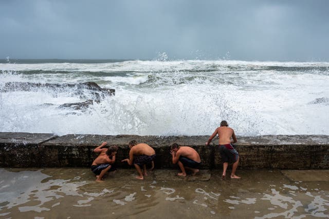 <p>A group evade a crashing wave on 6 March 2025 in Tweed Heads, Australia</p>