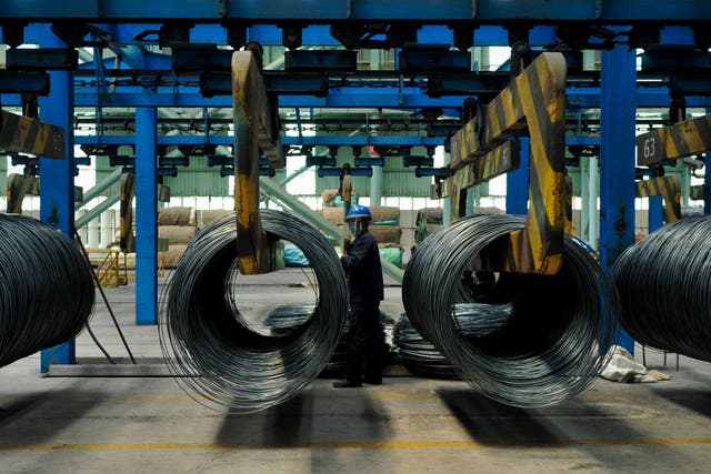 <p>A worker transfers steel cables at a steel factory in Qingdao in east China's Shandong province on 8 June, 2018</p>