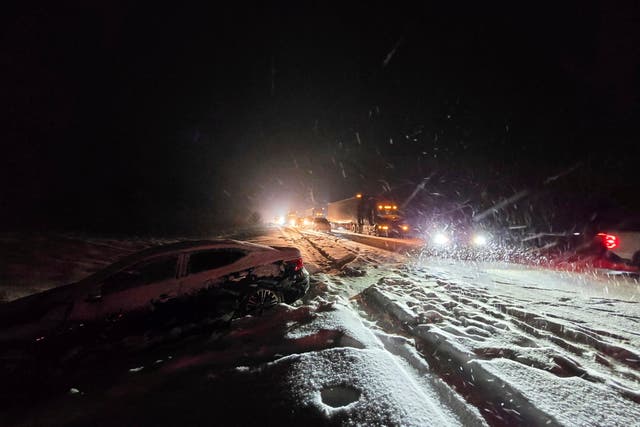 <p>Cars sit in traffic backed up for miles on Arizona’s Interstate 40 after a fresh dumping of snow</p>