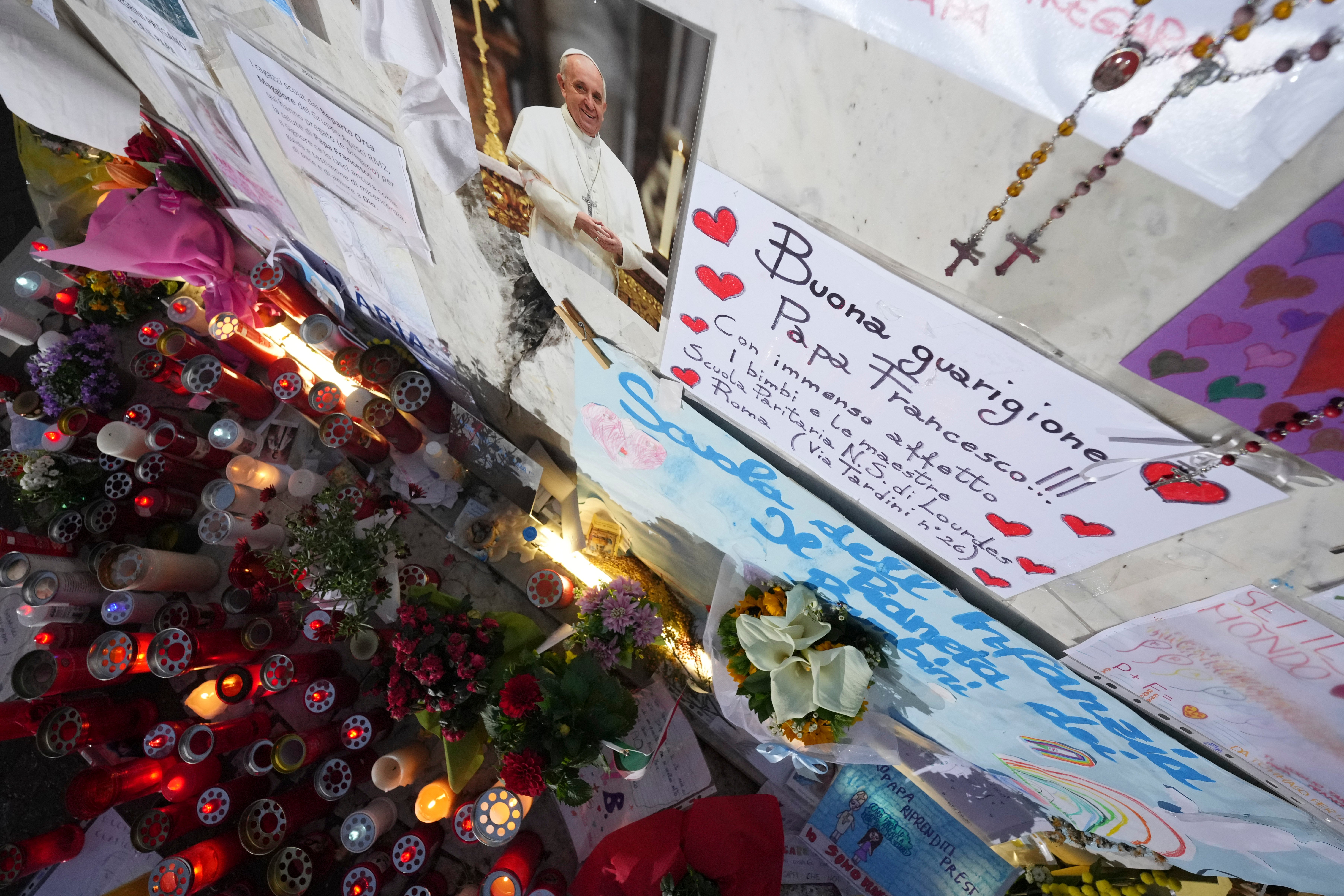 Candles for Pope Francis are seen in front of the Gemelli hospital