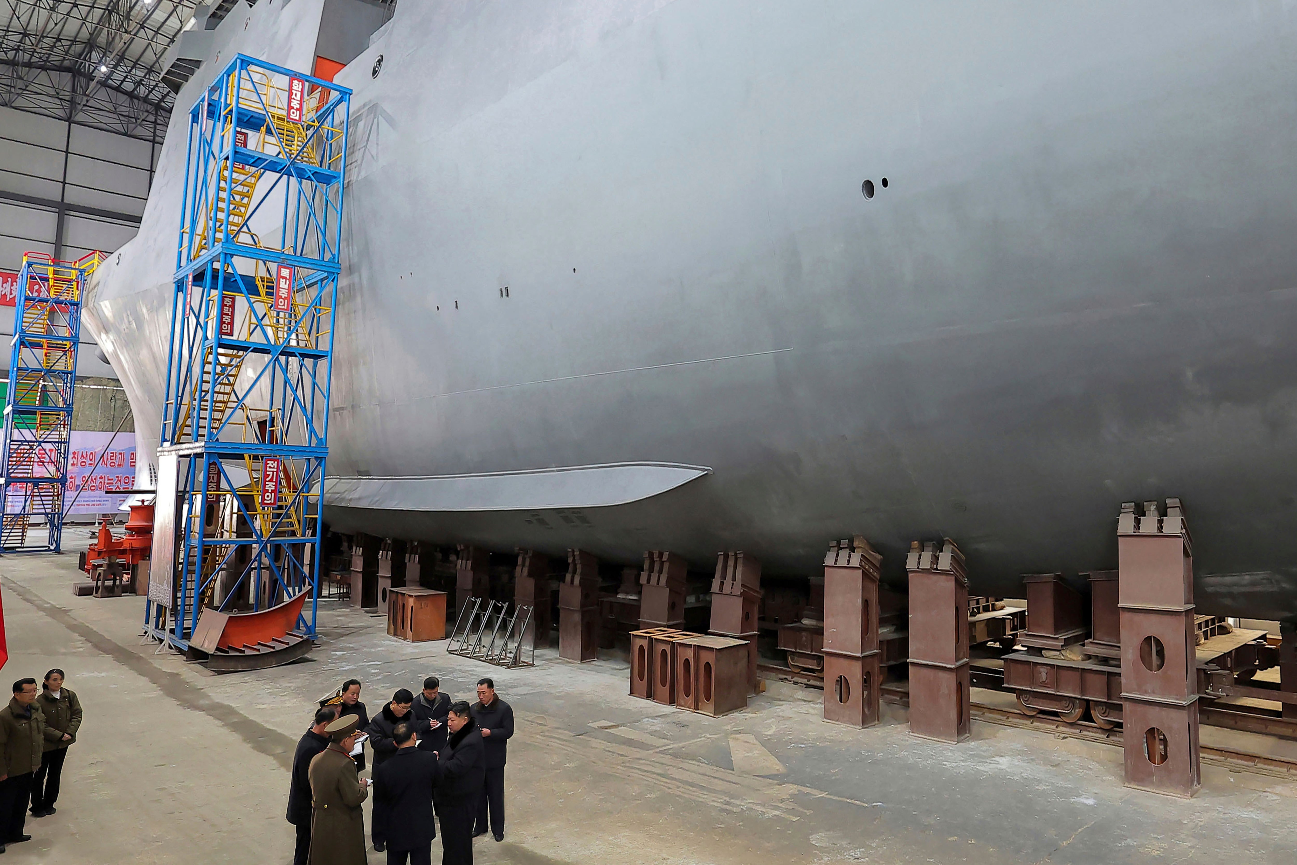 North Korean leader Kim Jong Un, bottom right, visits a shipyard to construct warships at an undisclosed place in North Korea