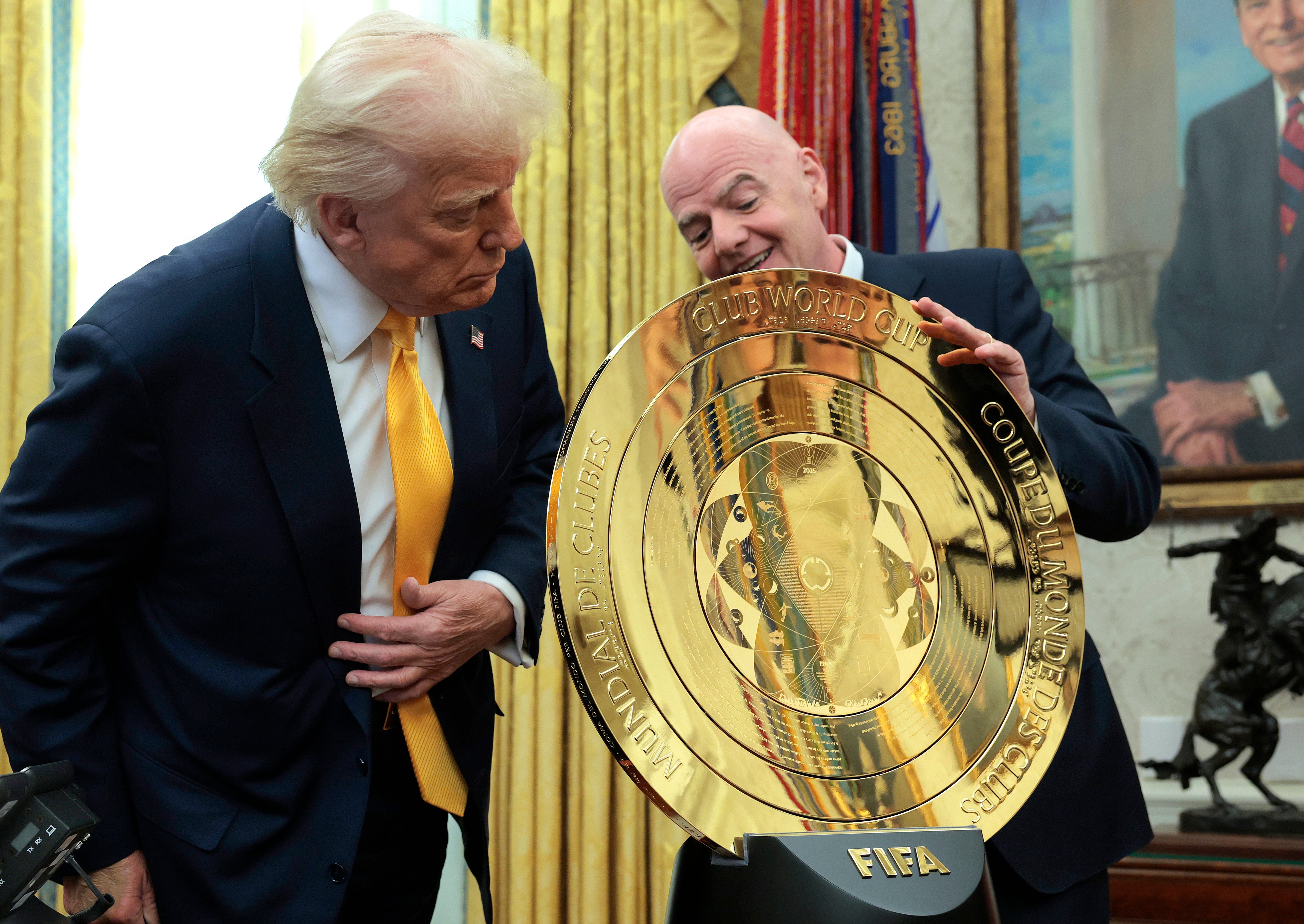 Trump and FIFA chief executive unveil the new golden Club World Cup shield in the Oval Office