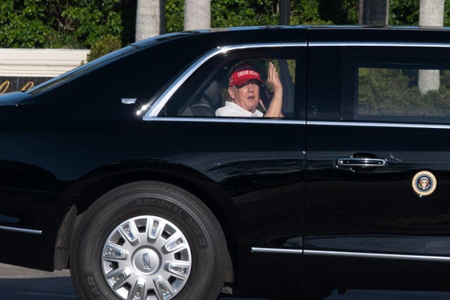 <p>President Donald Trump waves from his limousine as he arrives at his golf club in West Palm Beach on March 8, 2025</p>
