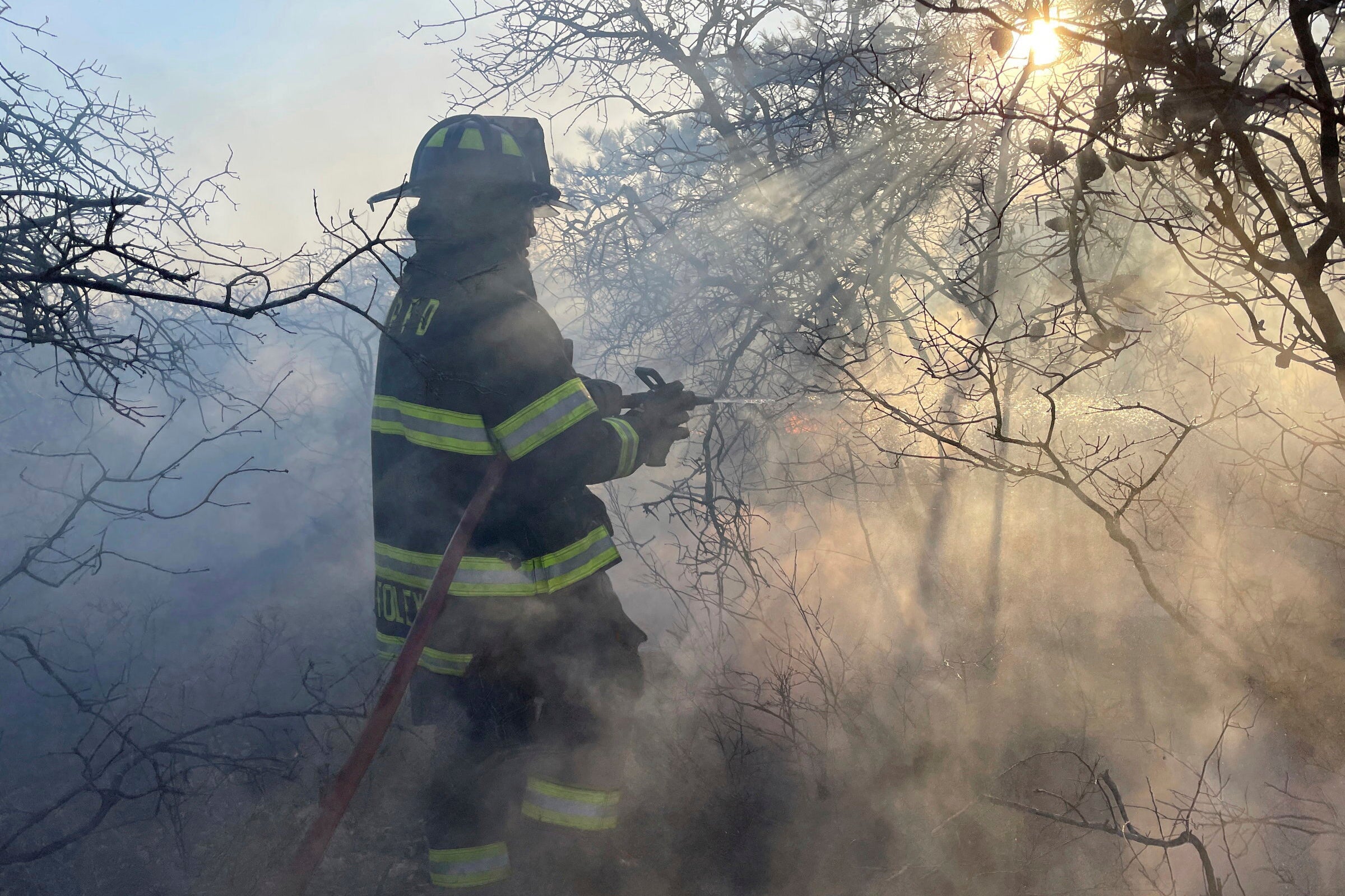 Firefighters respond to a brush fire in Suffolk County in New York's Long Island on March 8