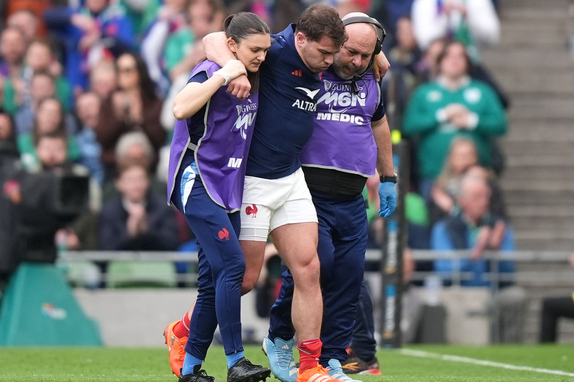 France’s Antoine Dupont was helped off the pitch after suffering a knee injury against Ireland