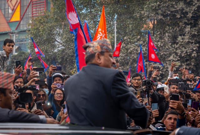 <p>Former King Gyanendra Shah greets the crowds upon his arrival at Nepal’s Tribhuvan International Airport</p>