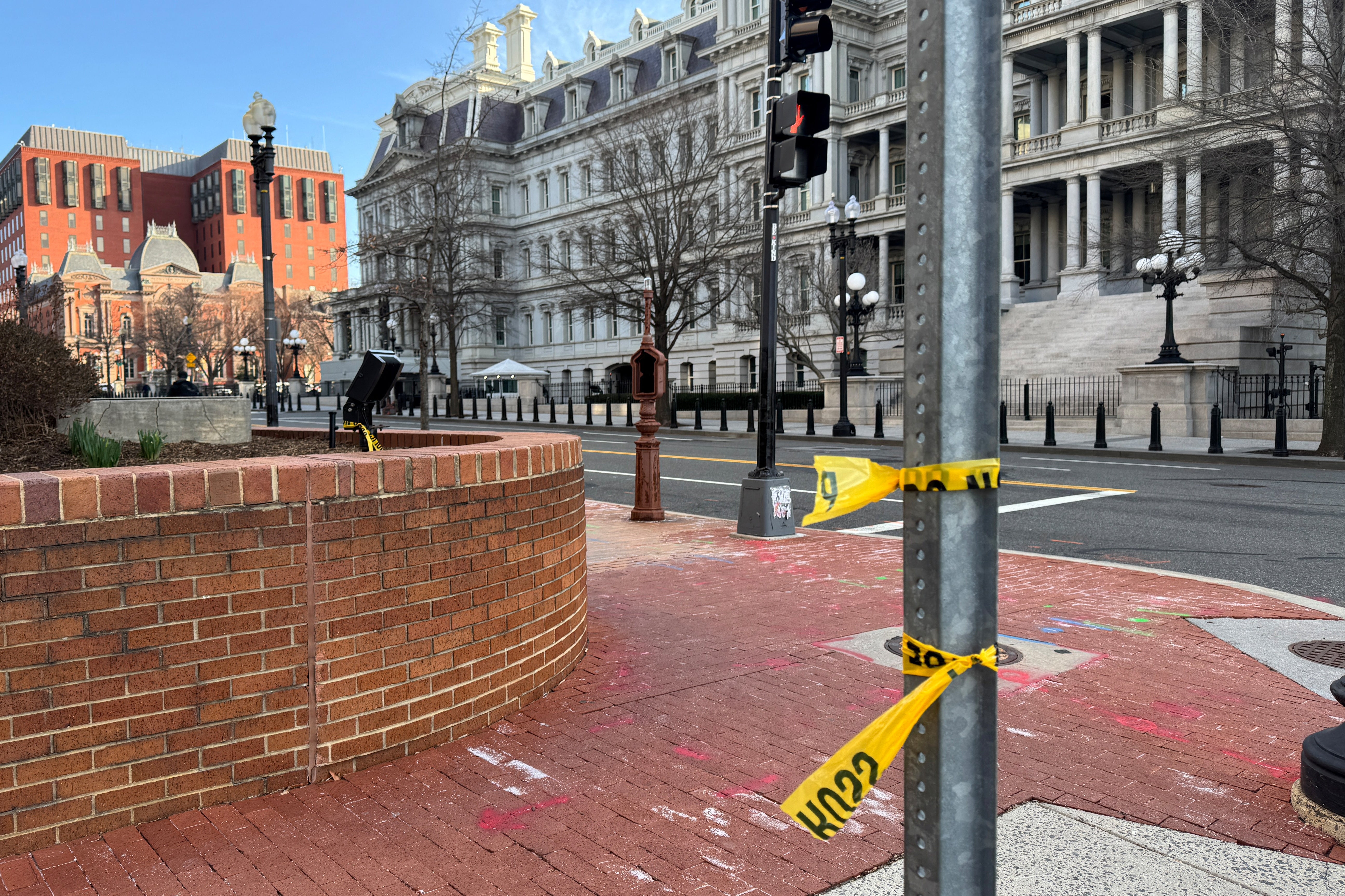 Police tape remains at the scene of an overnight shooting on a street bordering the White House complex, after Secret Service say they shot a man brandishing a firearm