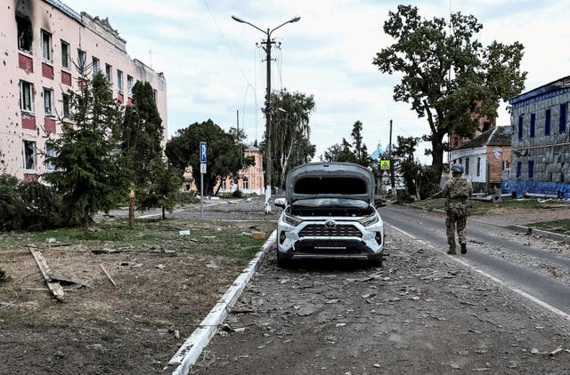 <p>A Ukrainian serviceman patrols a street in Sudzha in 2024</p>