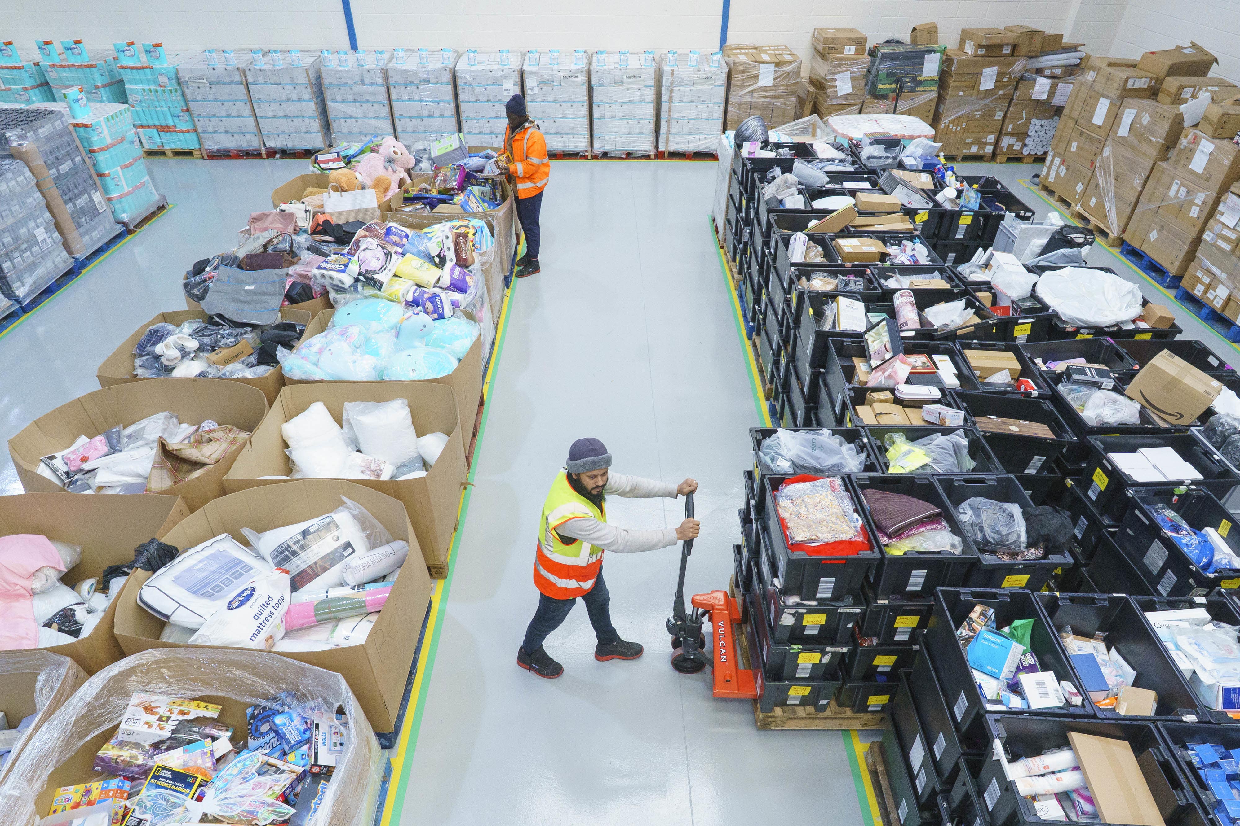 (l to r) Mohammed Konateh and Sabbir Ahmed Sumon pack goods at the new West Midlands Multibank in Birmingham (Dominic Lipinski Media Assignments/PA)