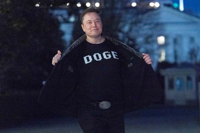 <p>Elon Musk flashes his t-shirt that reads "DOGE" to the media as he walks on South Lawn of the White House. The Elon Musk-led service is reportedly looking to rebrand after a string of negative headlines and public missteps</p>