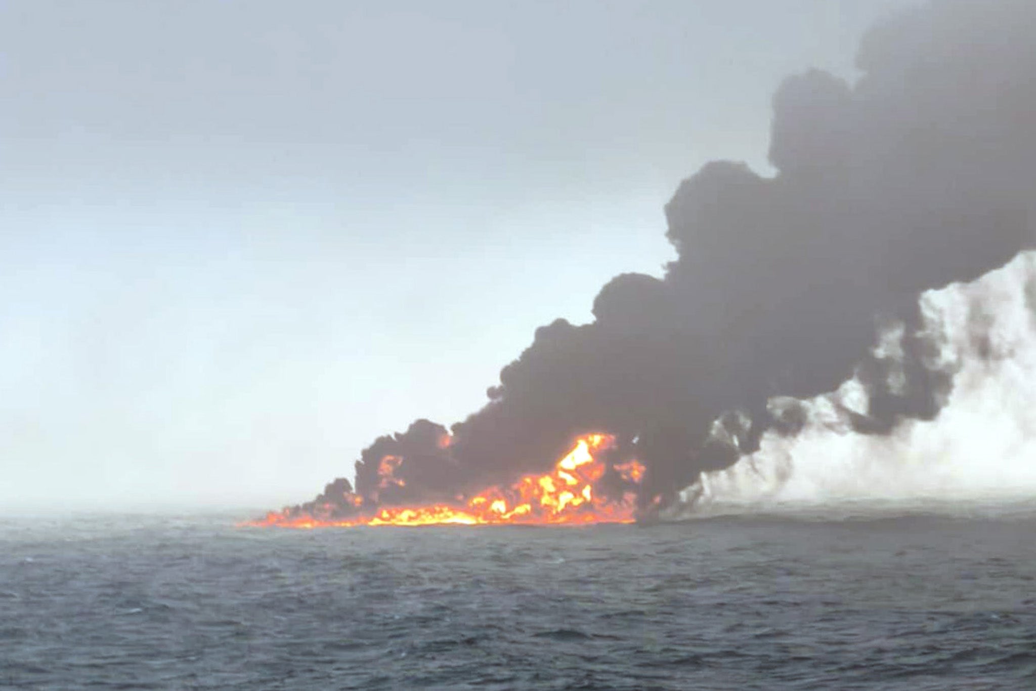 Smoke billowing into the air after a crash between an oil tanker and a cargo ship off the coast of East Yorkshire