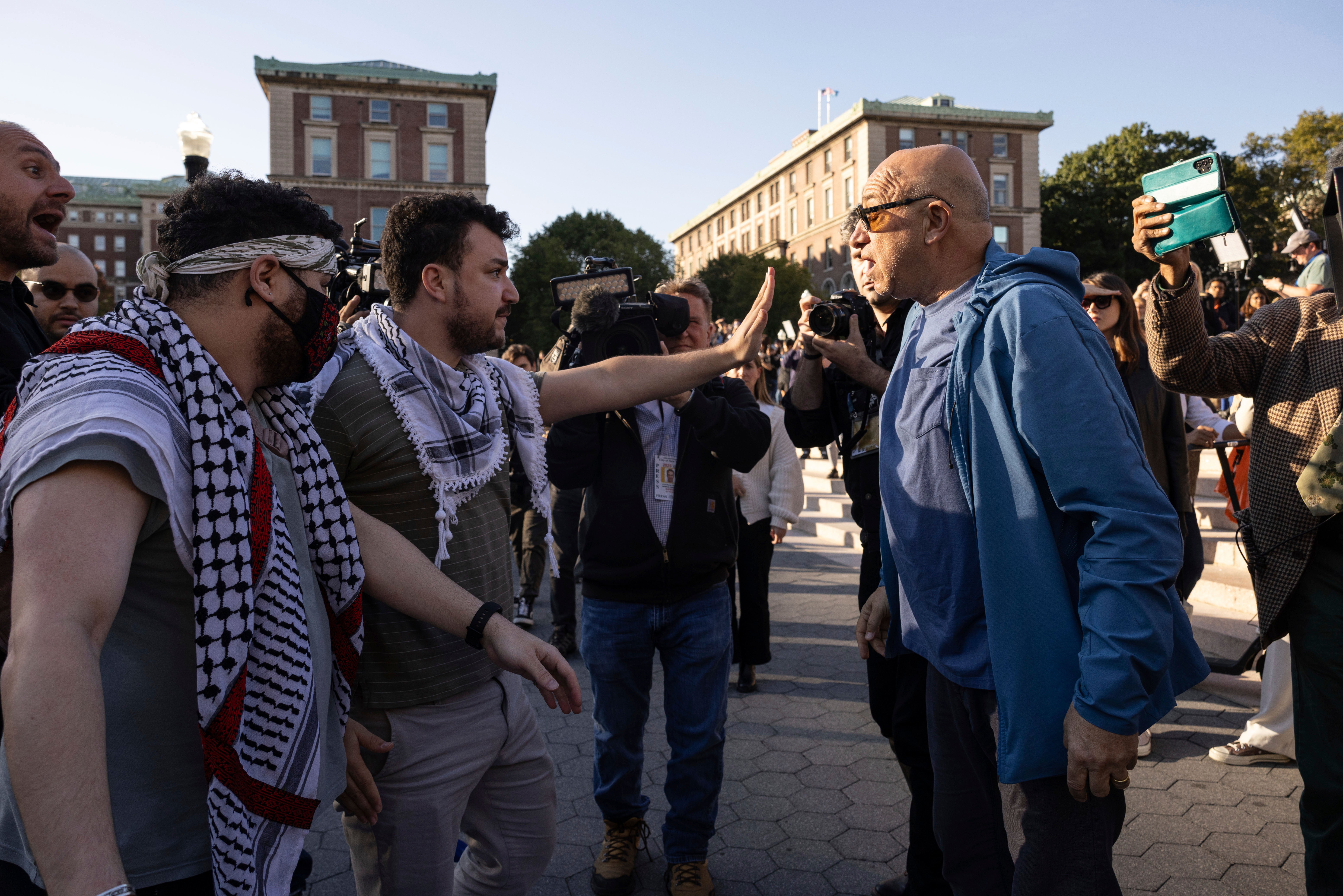 Pro-Palestinian demonstrator Mahmoud Khalil, second from left, debates with a pro-Israel demonstrator during a protest at Columbia University on Oct. 12, 2023