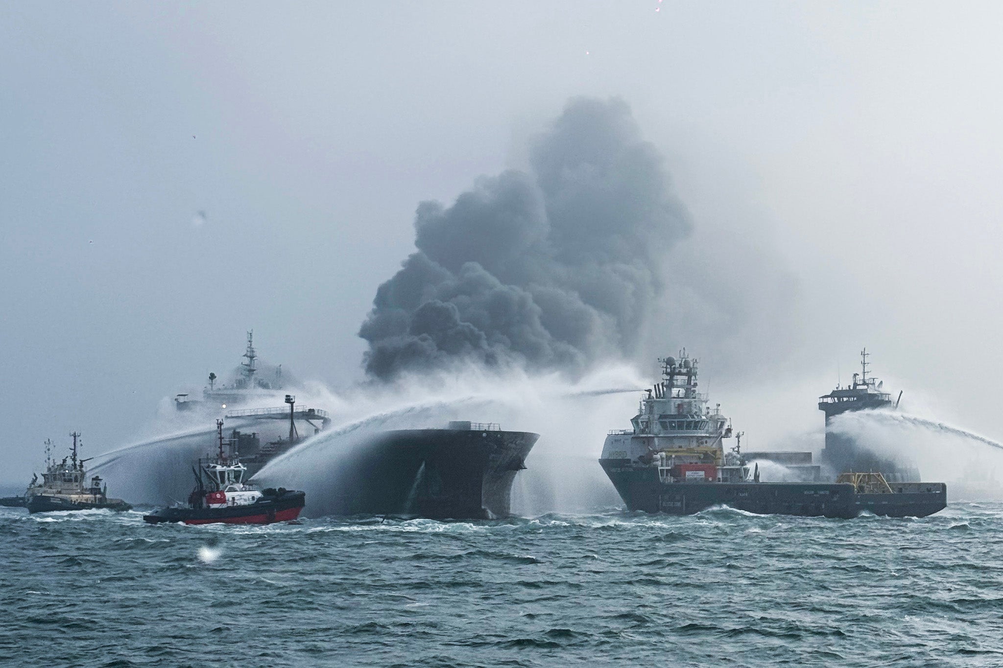 Fire and Rescue Services try to extinguish the flames that broke out immediately on Monday morning