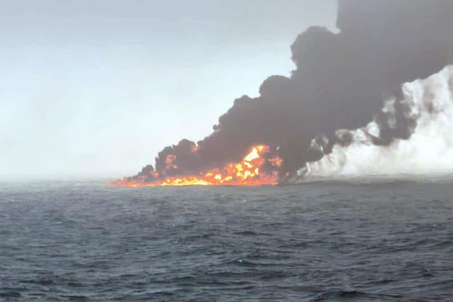 <p>Black smoke billowing into the air after a crash between an oil tanker and a cargo ship off the coast of East Yorkshire (Bartek Smialek/PA)</p>