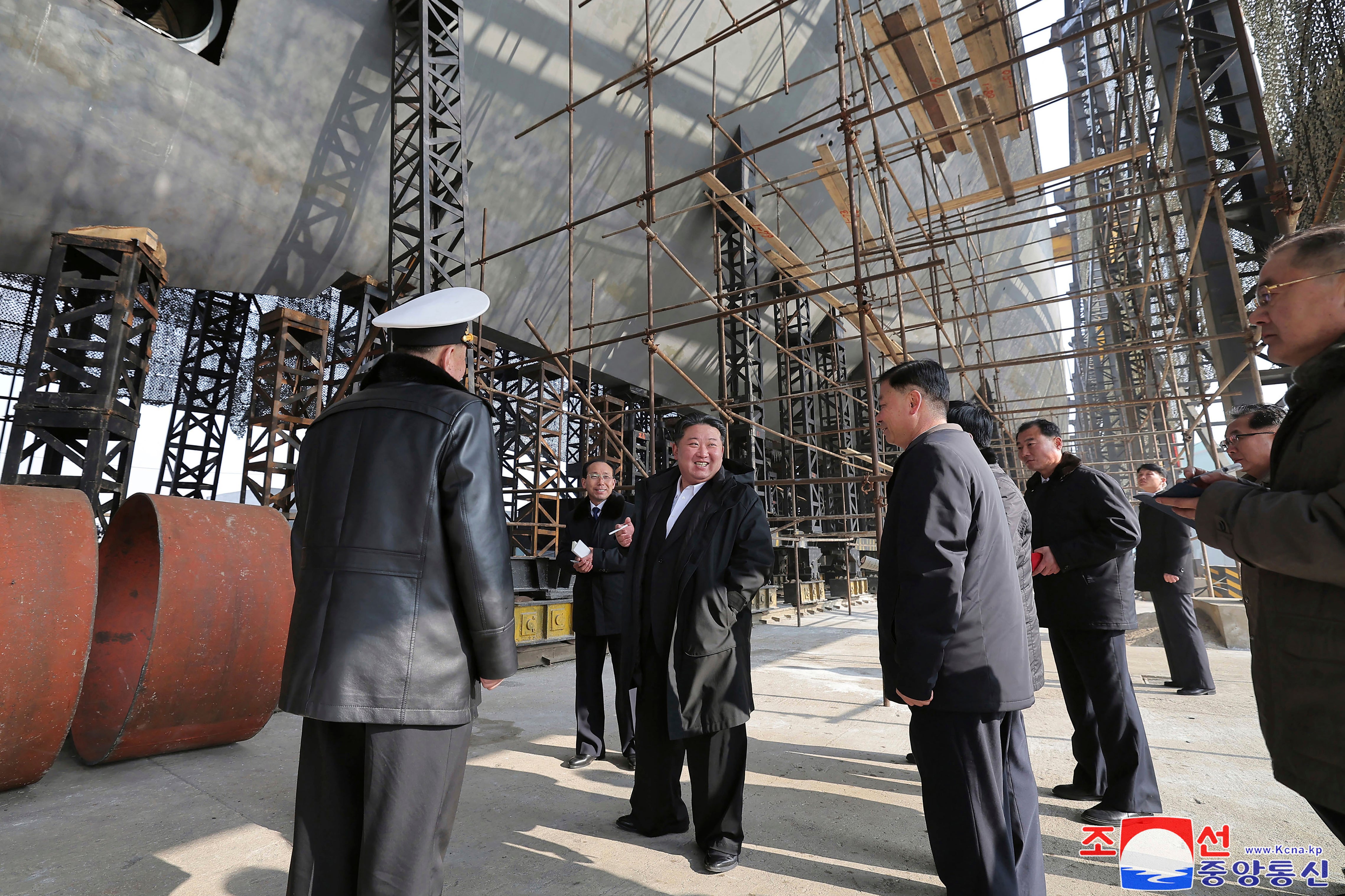 Photo provided on 8 March 2025 by the North Korean government shows leader Kim Jong Un, center, touring a shipyard that constructs warships at an undisclosed location