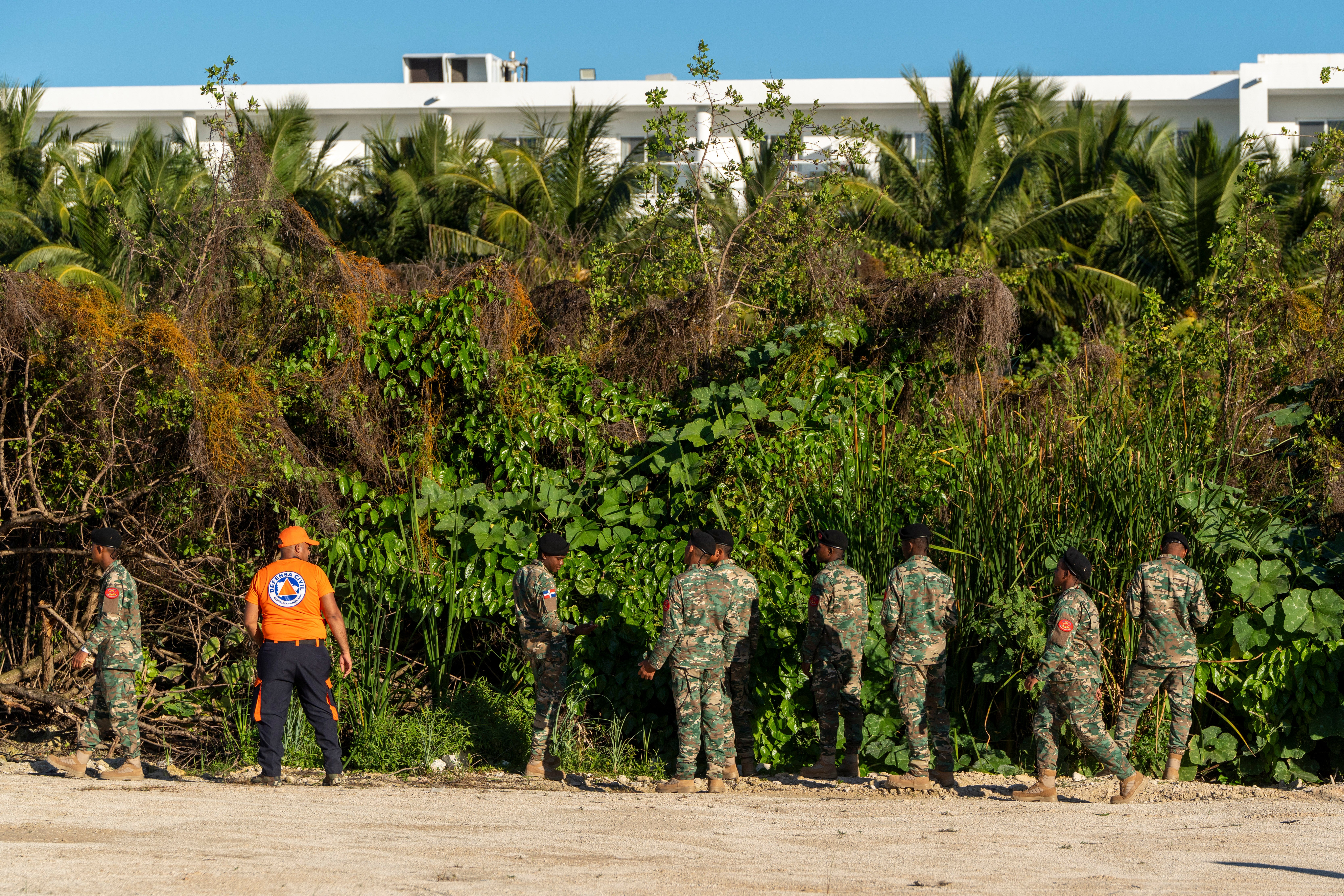 Military personnel and civil defense members search for Konanki on a beach in Punta Cana last week