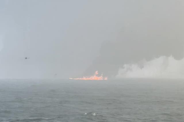 Handout photo of black smoke billowing into the air after a crash between an oil tanker and a cargo ship off the coast of East Yorkshire (Bartek Smialek/PA)