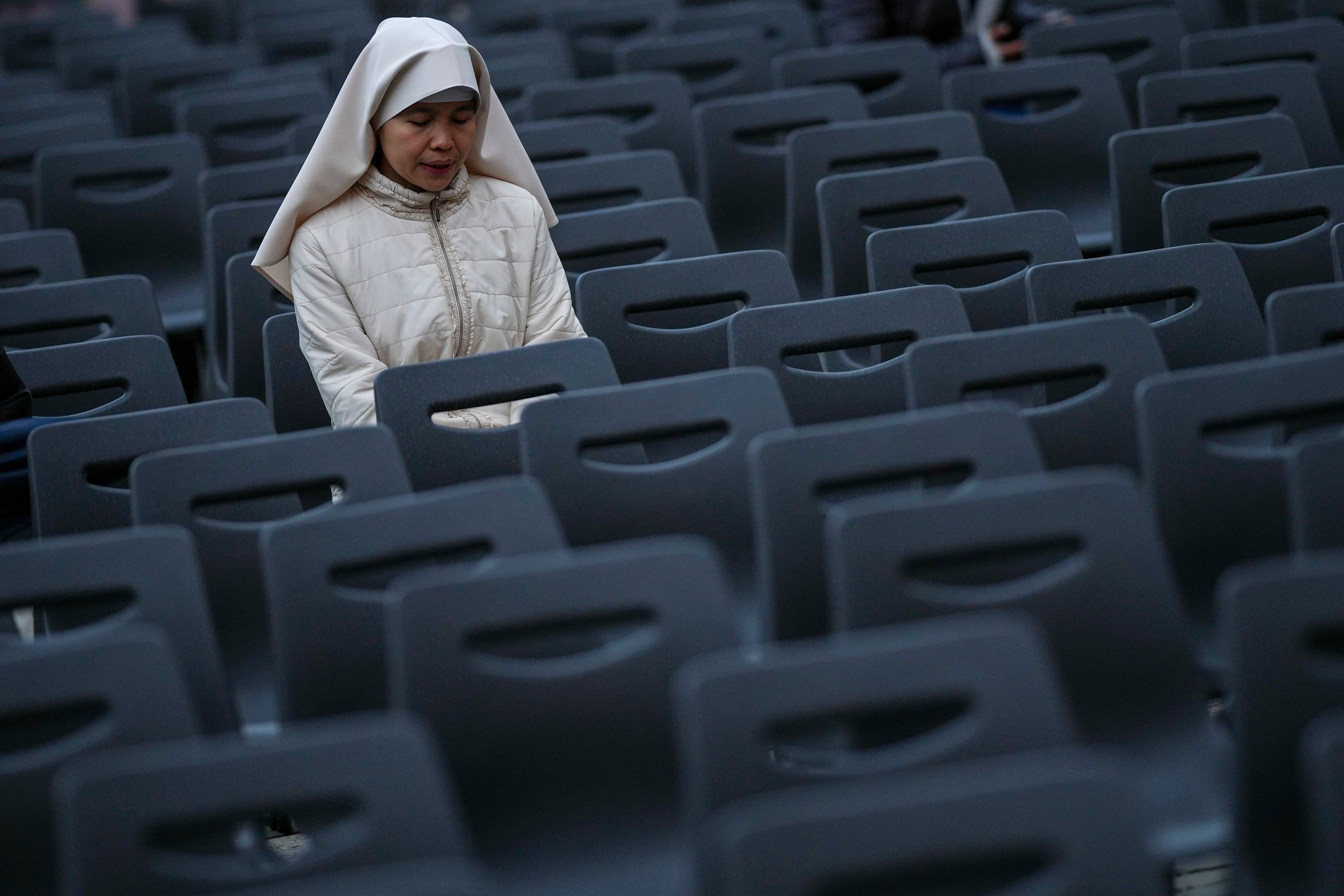 A nun attends a rosary prayer for Francis at Vatican Square