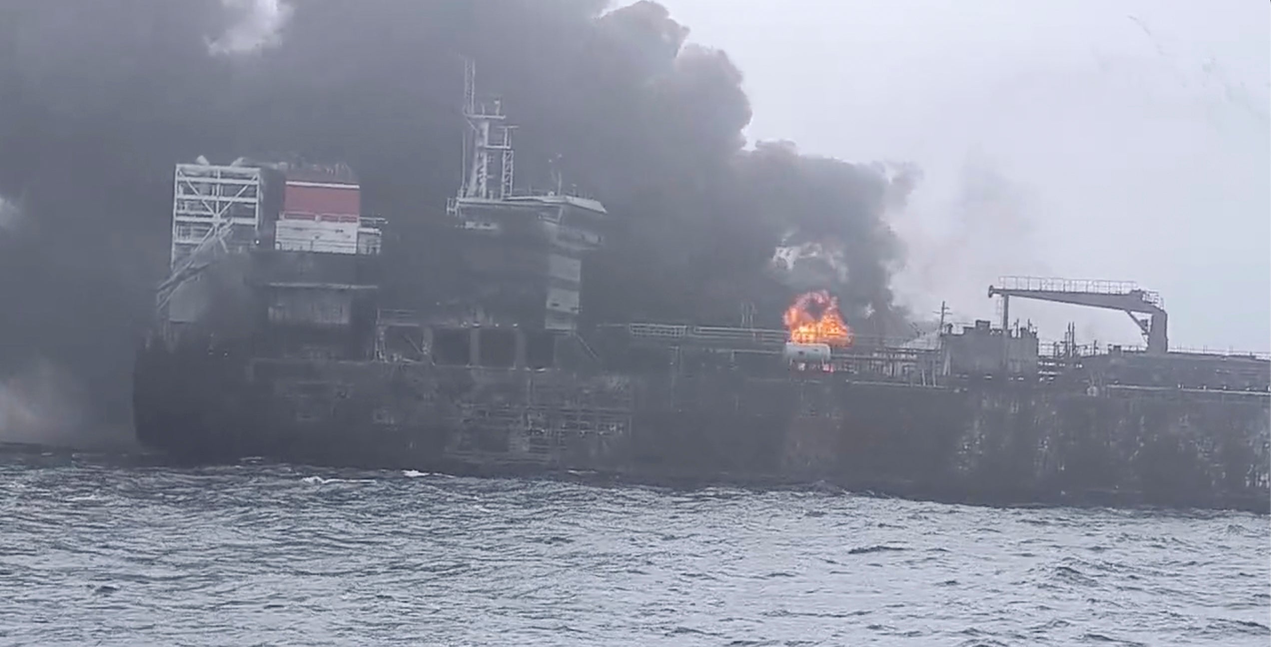 Rescue crews work on site after a cargo ship was hit by a tanker carrying jet fuel for the US military off eastern England