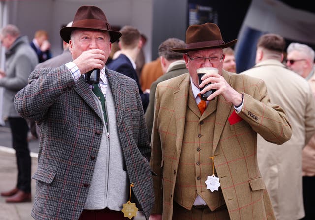 <p>Racegoers with pints of Guinness on day one of the 2025 Cheltenham Festival</p>