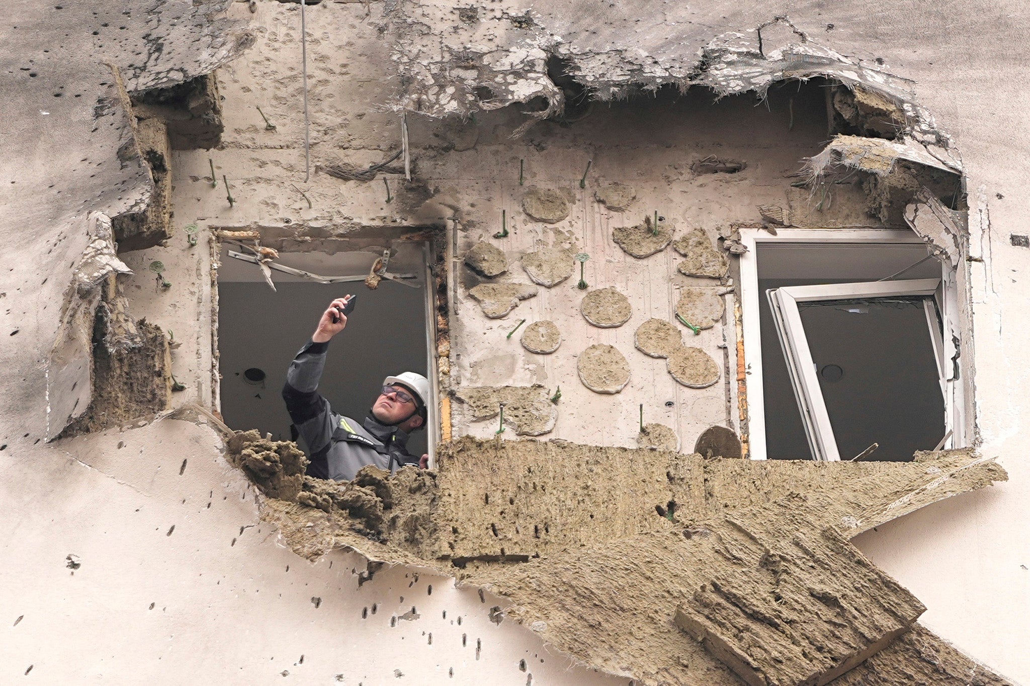 An interrogator looks at an apartment that a Ukrainian unmanned aircraft crashed in Sapronovo Village outside Moscow