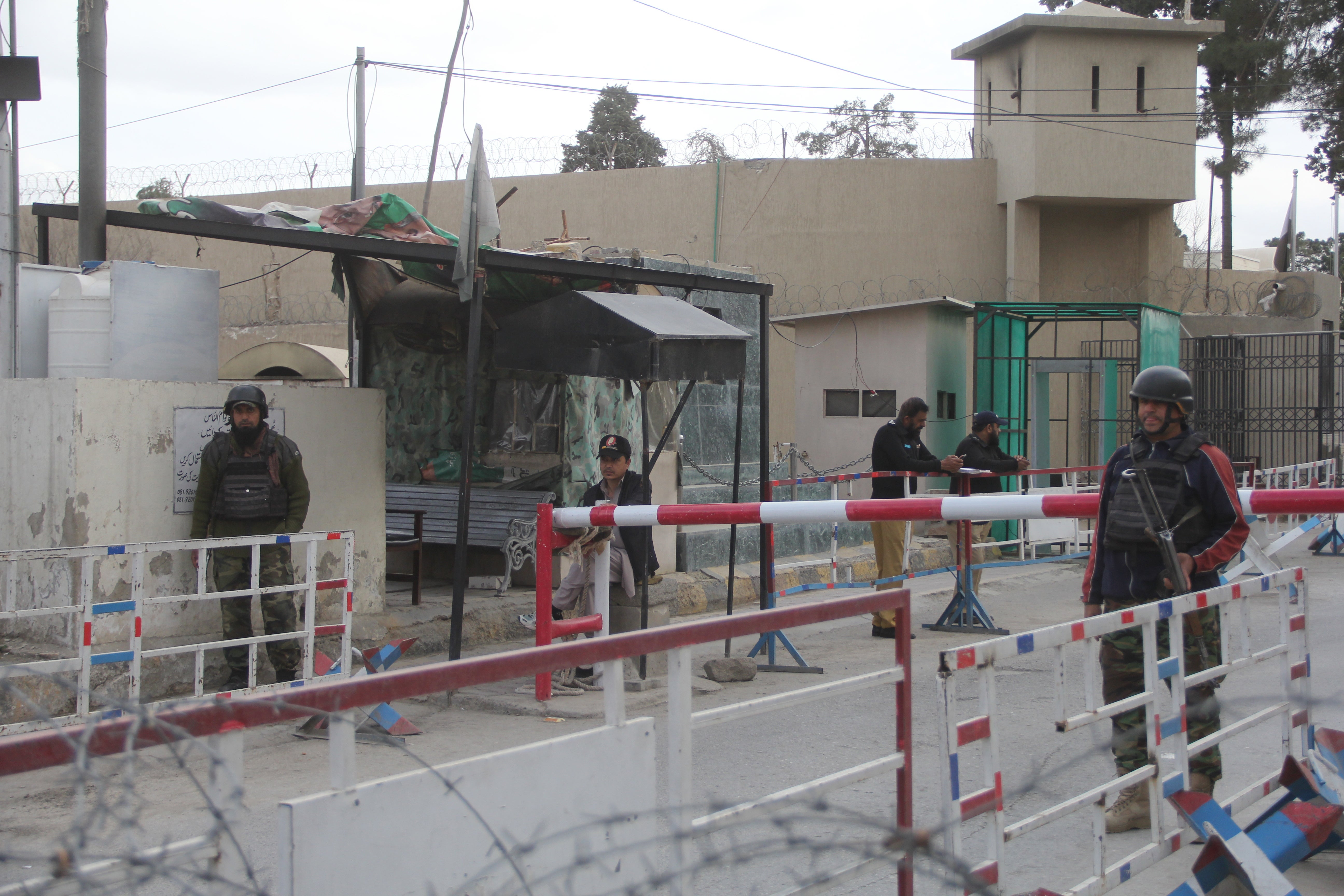 Pakistani security officials inspect vehicles at a checkpoint after security was intensified following a suspected militant attack on a passenger train on Tuesday