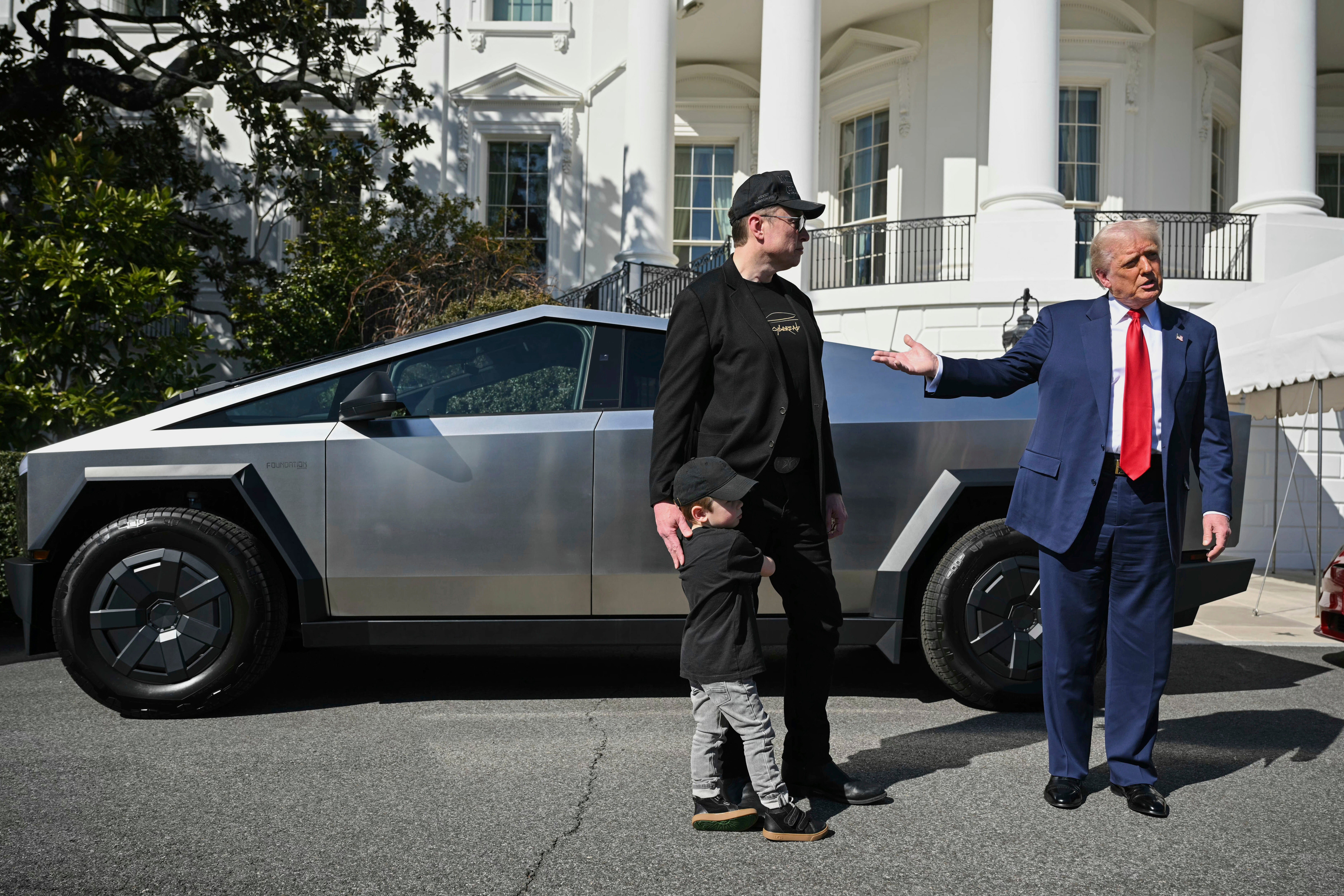 President Donald Trump and Tesla CEO Elon Musk, along with his son X on the South Lawn of the White House