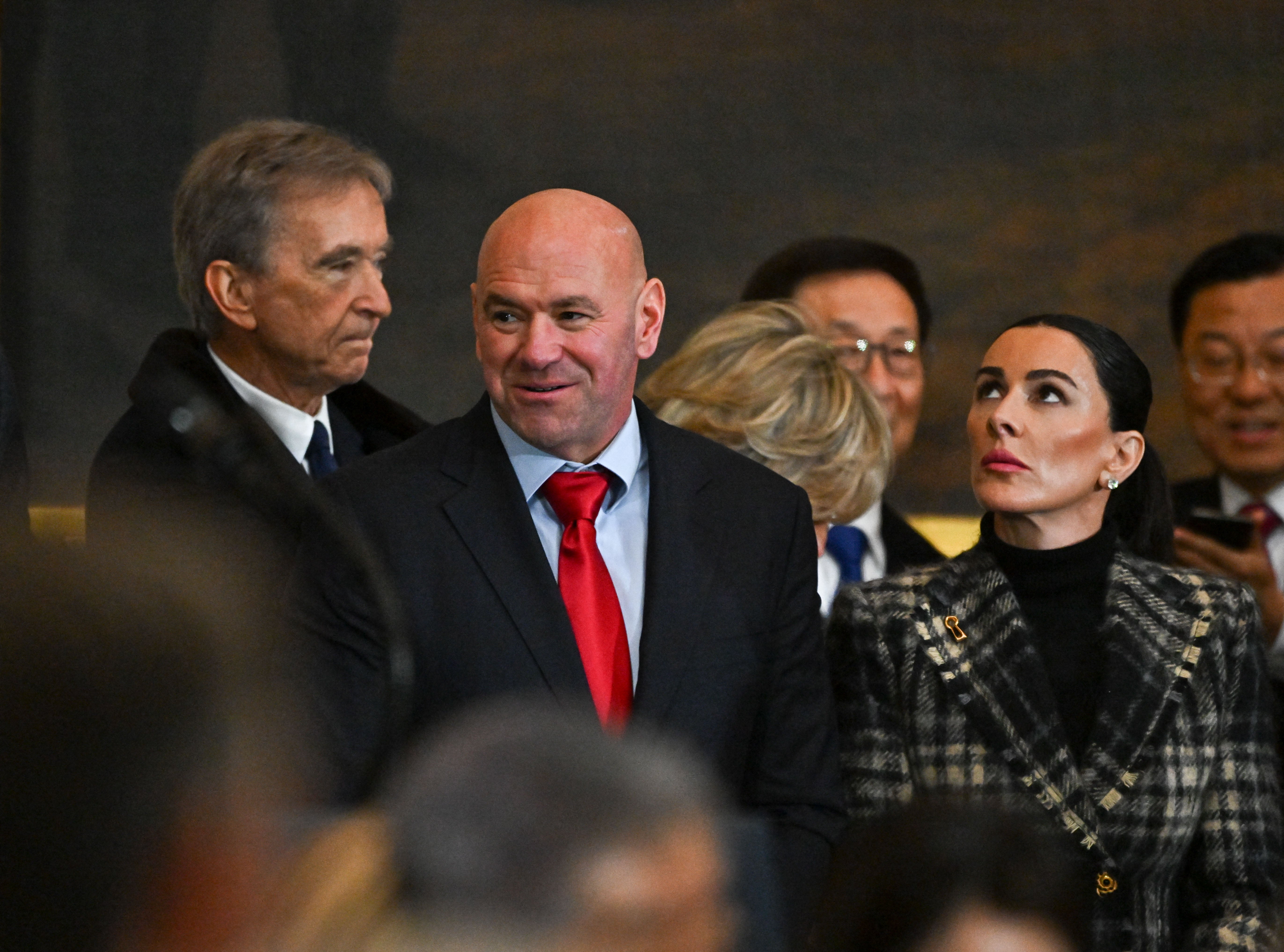 LVMH CEO Bernard Arnault (left) and UFC Founder Dana White (center) pictured attending Trump's inauguration. Arnault's net worth has fallen $5 billion since January 20