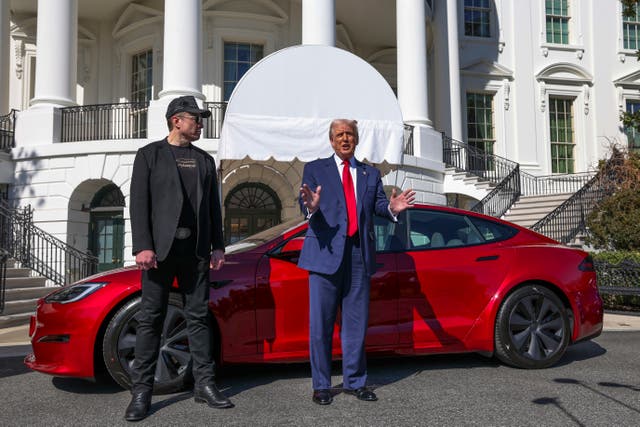 <p>President Donald Trump promotes a Tesla car from the White House’s south lawn alongside Elon Musk</p>