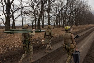 Ukrainian servicemen of the 3rd Operational Assignment Spartan Brigade carry equipment as they search for a location to launch a drone during a military training in Dnipropetrovsk Region on 10 March 2025
