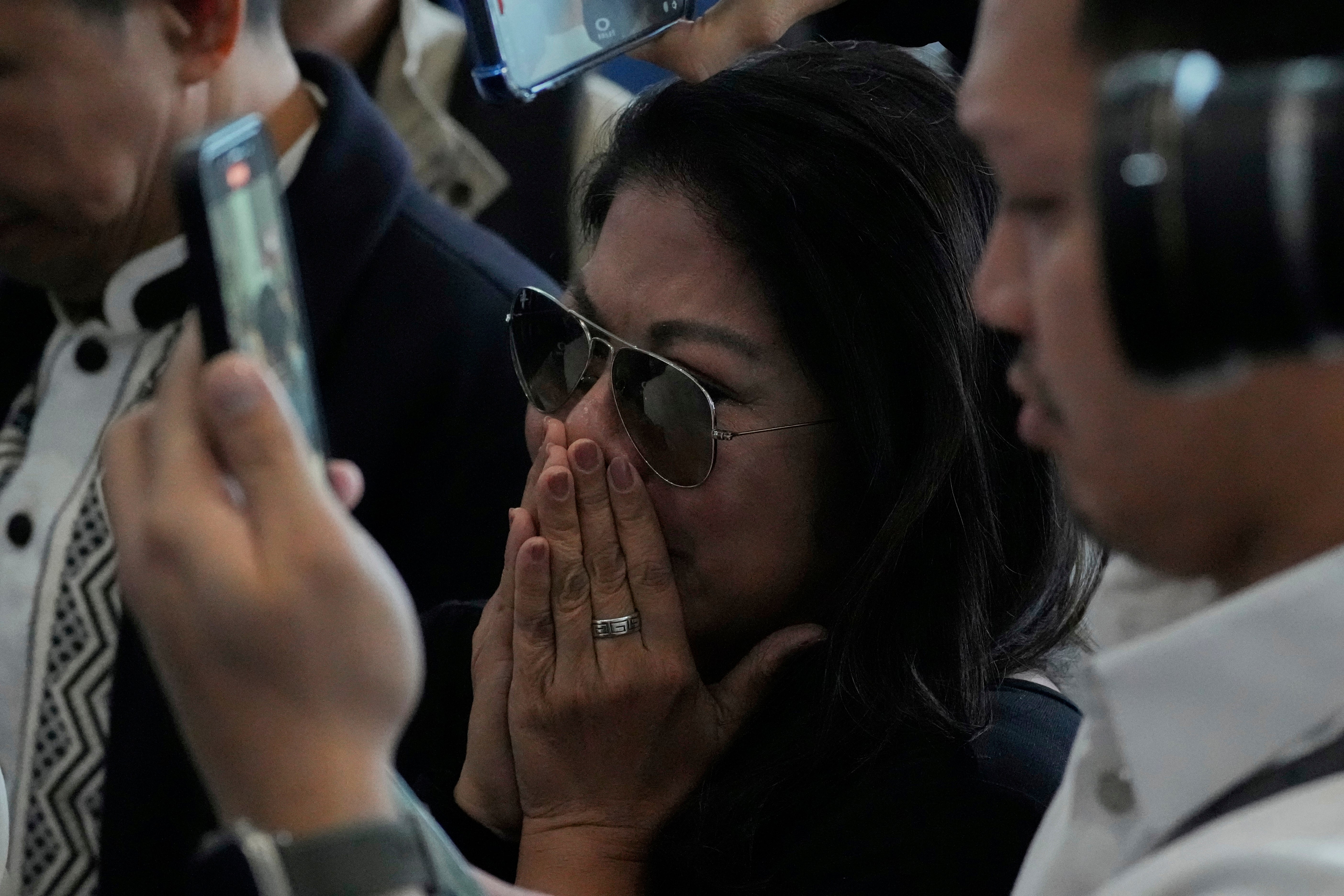 A supporter of Rodrigo Duterte reacts upon finding out he has been arrested at the airport in Manila