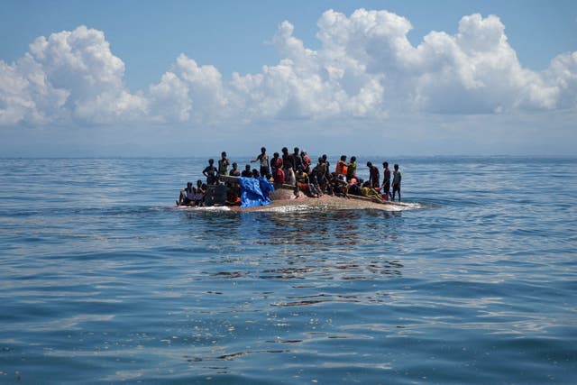 <p>File Rohingya refugees are seen on a capsized boat before being rescued in the waters of West Aceh, Indonesia, 21 March 2024</p>