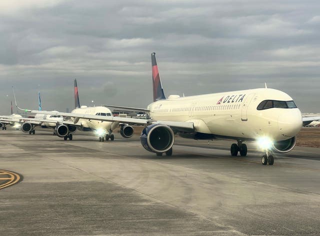 <p>Lining up: Delta Air Lines aircraft at New York JFK. The carrier has abandoned expansion plans from July</p>