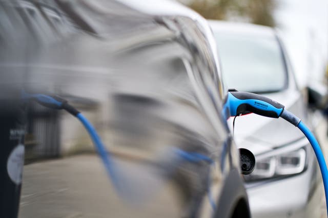 A Tesla car plugged into a Source London EV charging point in central London (John Walton/PA)