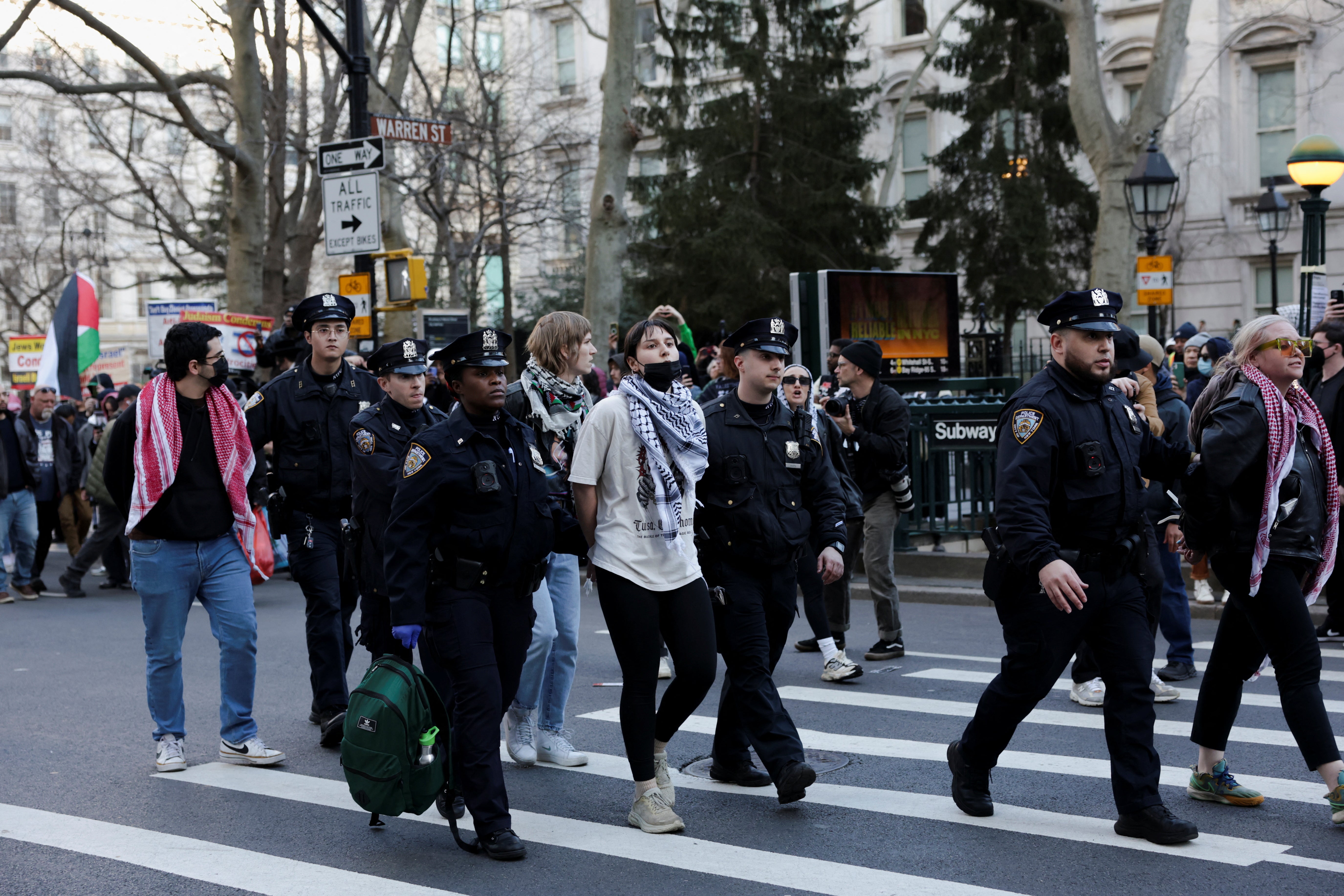 A demonstrator is led away