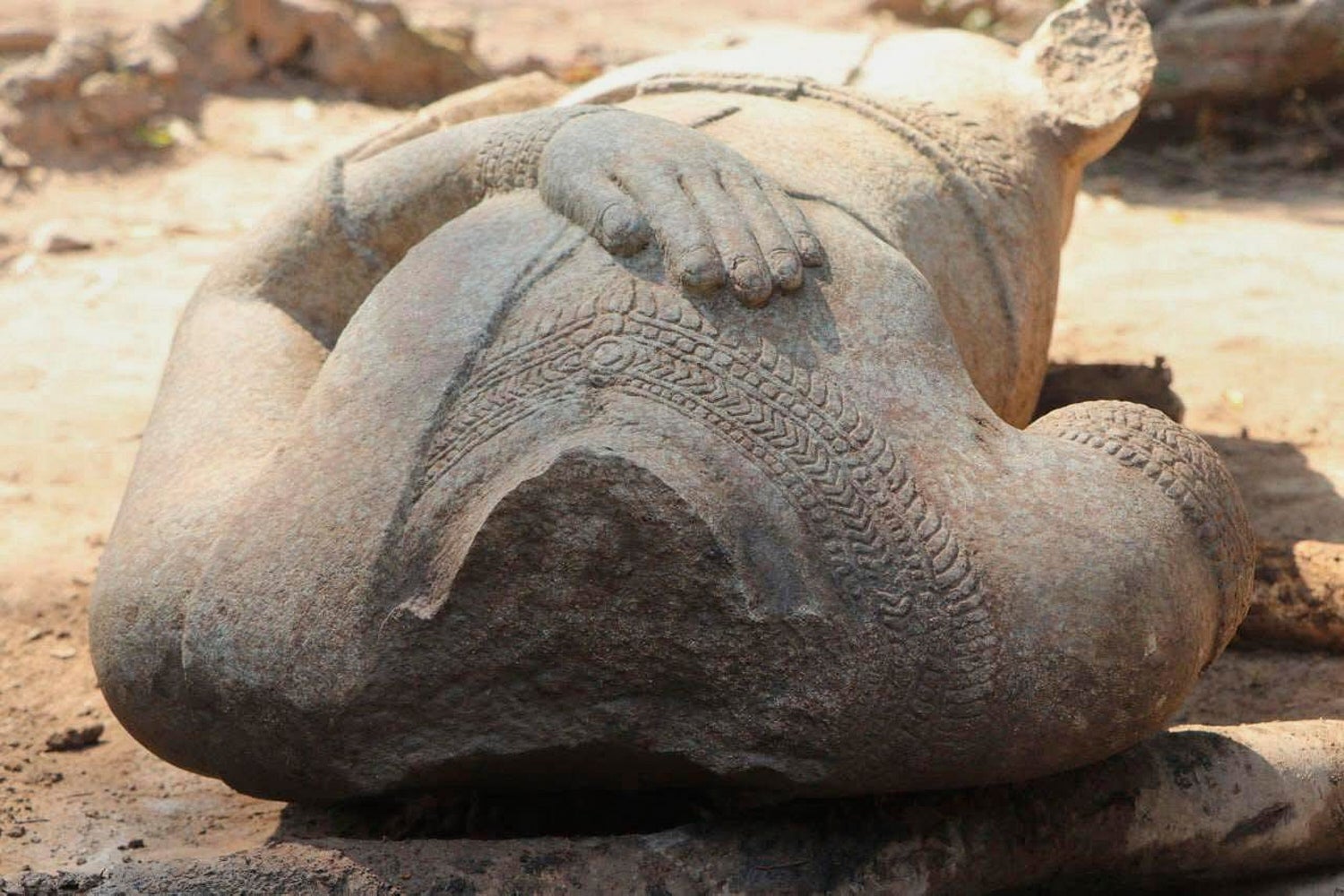 A headless statue of a Buddha found at Cambodia’s Angkor site