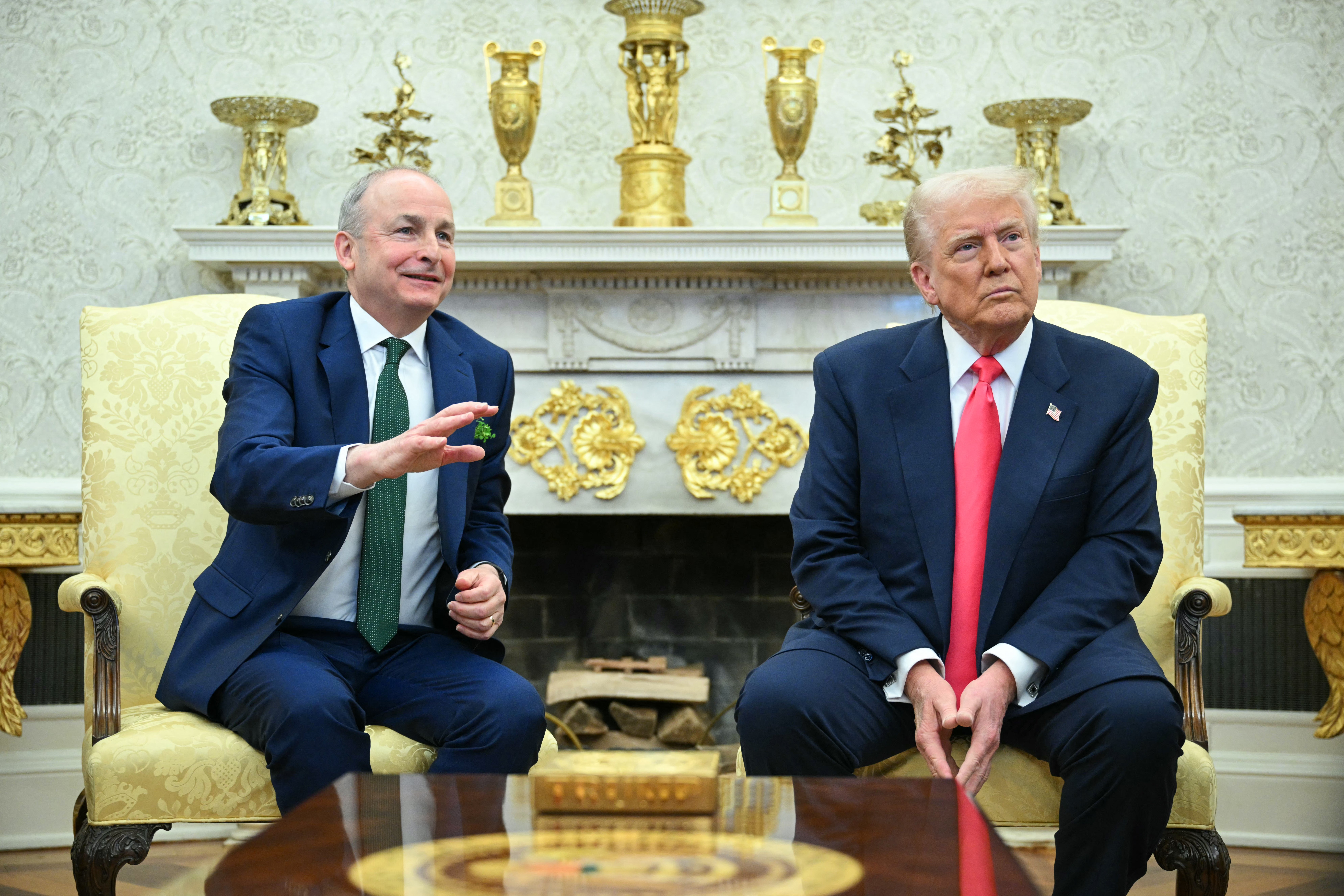 U.S. President Donald Trump surrounded by gold ornaments as he meets with Irish Prime Minister Micheal Martin in the Oval Office of the White House