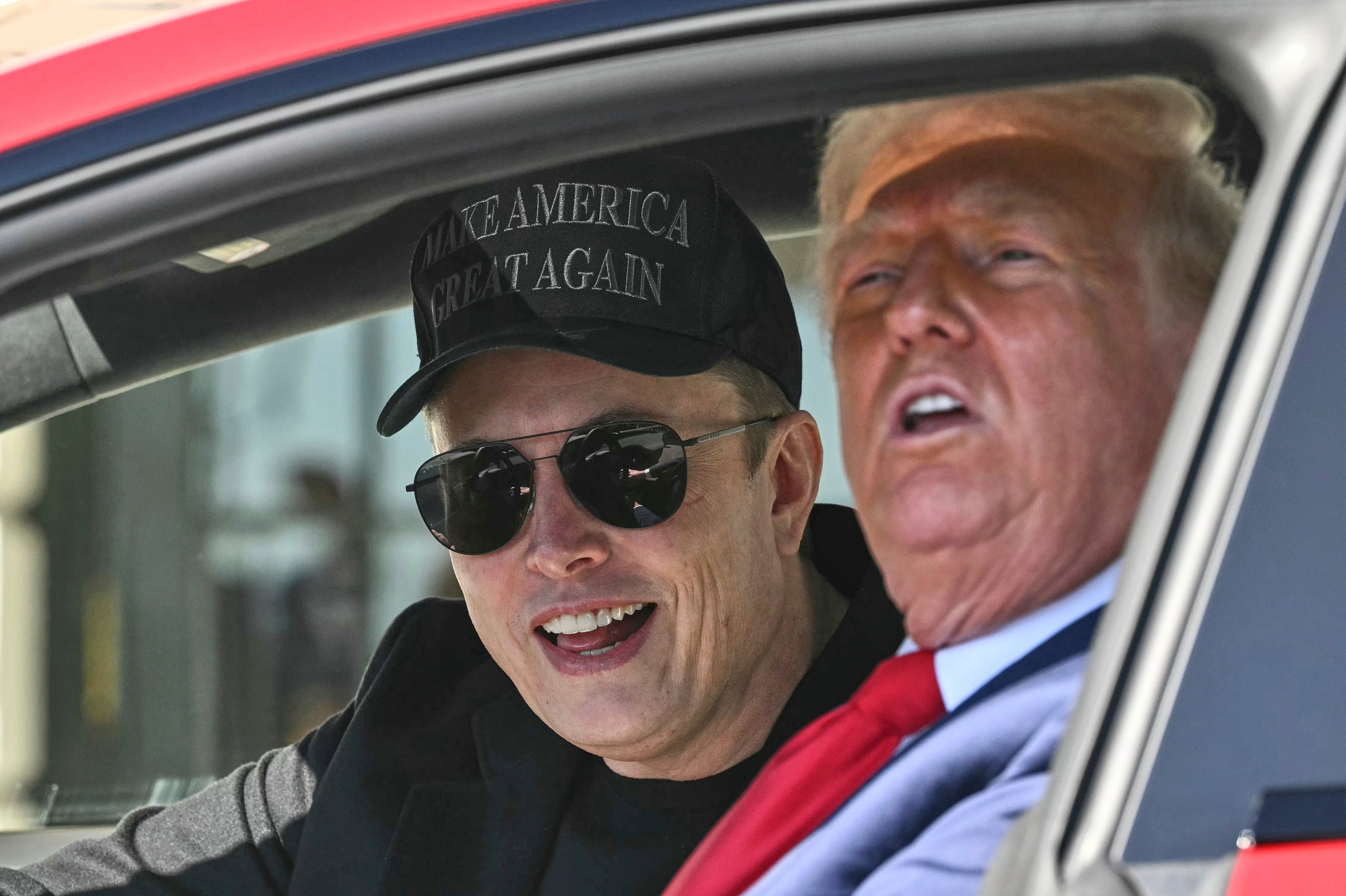 Elon Musk (left) sat with President Donald Trump as he purchased a new Tesla Model S on the White House south lawn Tuesday